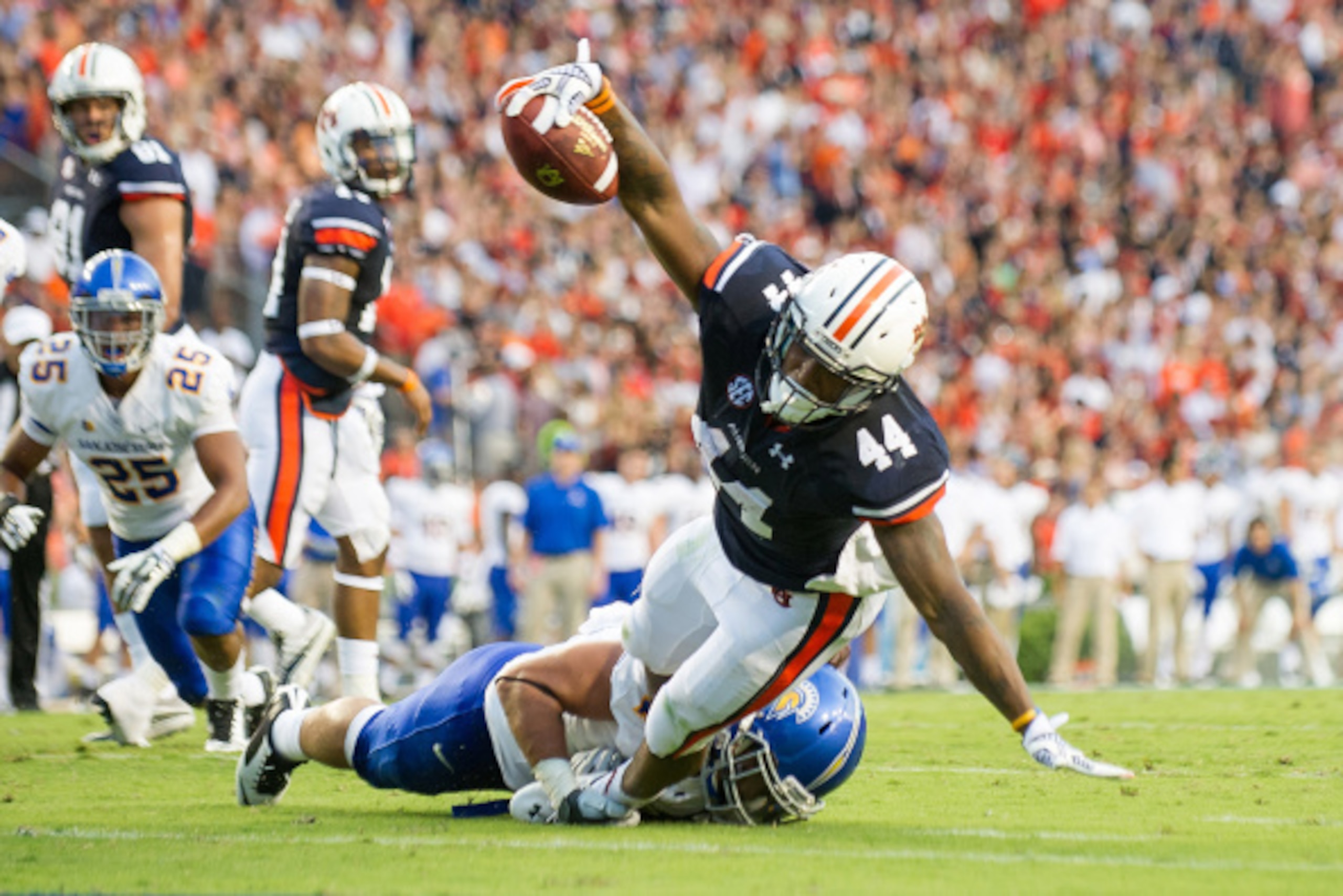 AUBURN, AL - SEPTEMBER 6: Running back Cameron Artis-Payne #44 of the Auburn Tigers falls into the enzone for a touchdown while being tackled by linebacker Christian Tago #4 of the San Jose State Spartans on September 6, 2014 at Jordan-Hare Stadium in Aub