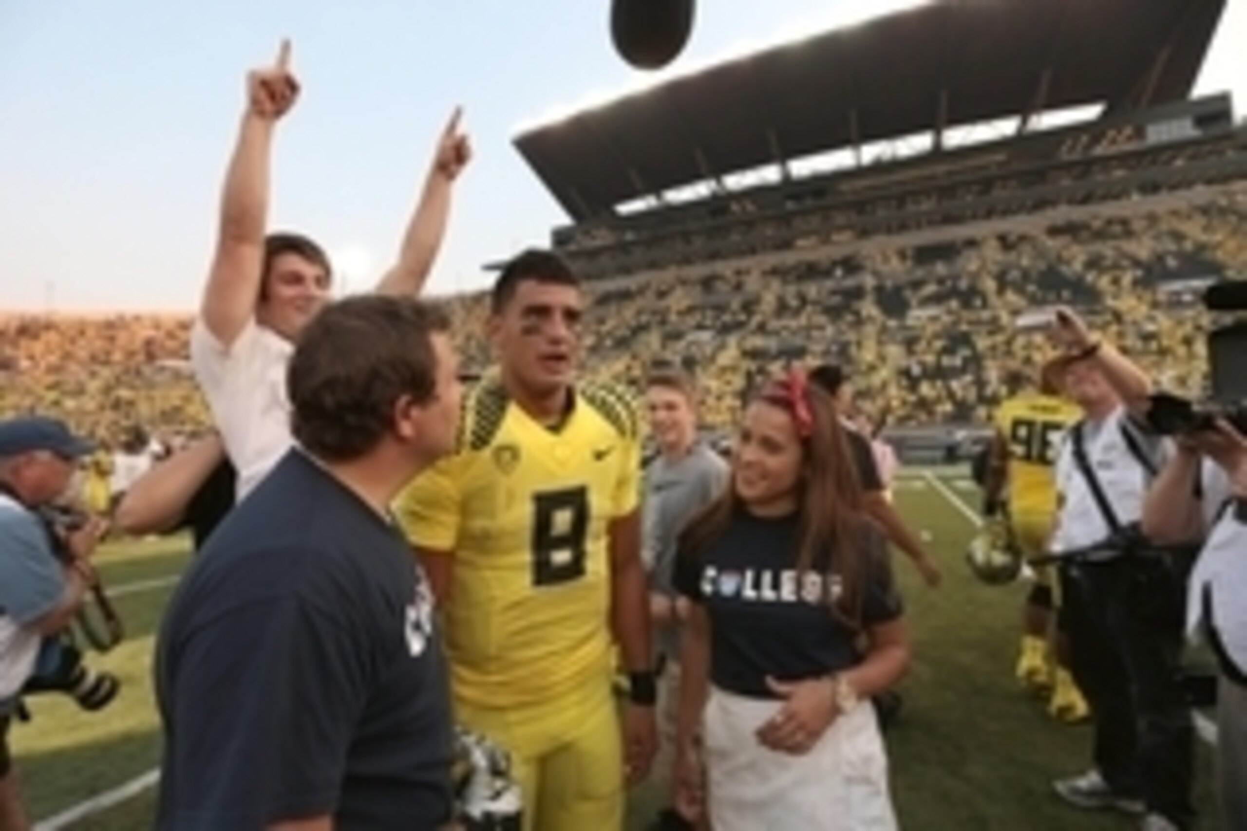 Sep 6, 2014; Eugene, OR, USA; Oregon Ducks quarterback Marcus Mariota (8) walks with fans after the game against the Michigan State Spartans at Autzen Stadium. Mandatory Credit: Scott Olmos-USA TODAY Sports