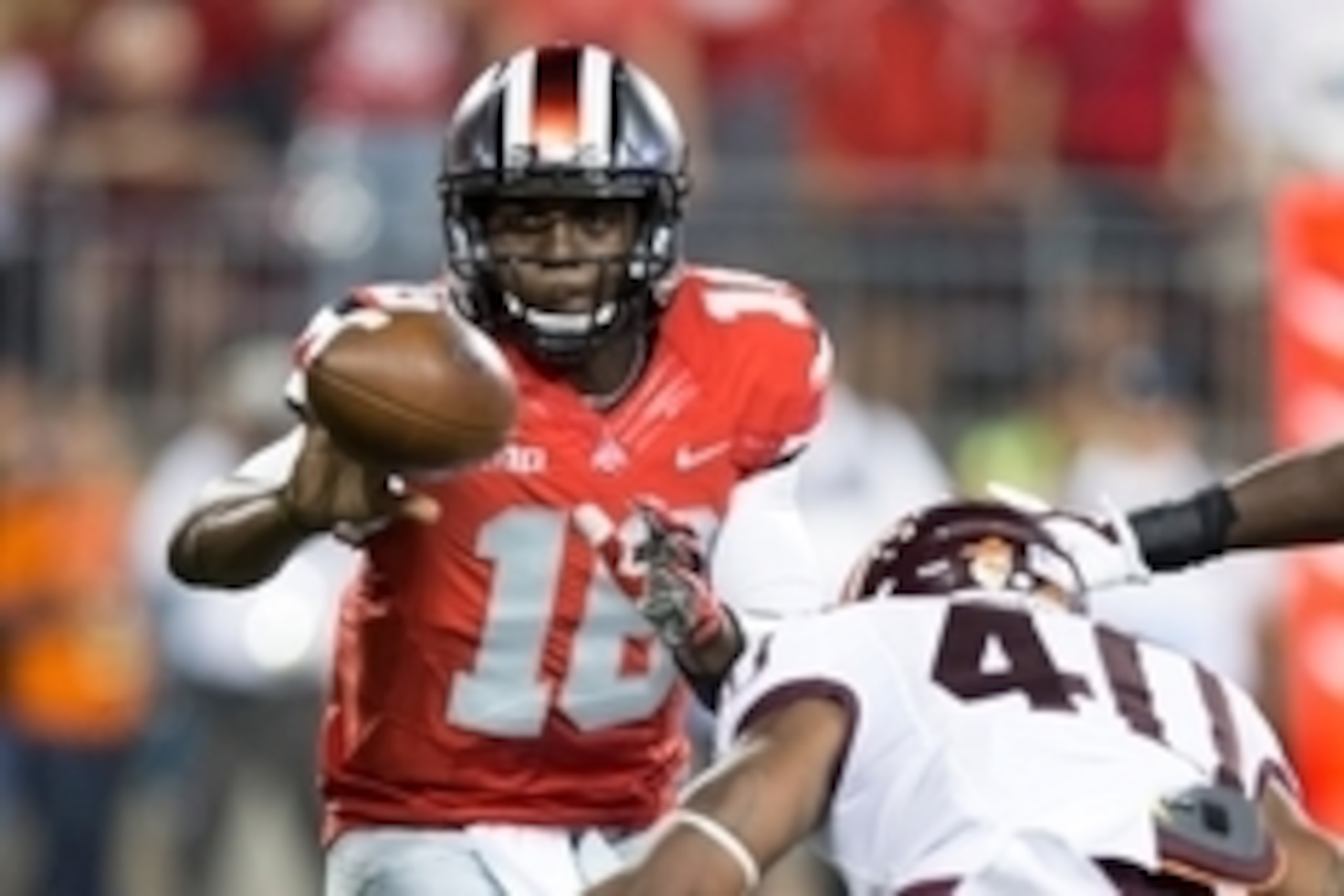 Sep 6, 2014; Columbus, OH, USA; Ohio State Buckeyes quarterback J.T. Barrett (16) pitches the ball under pressure from Virginia Tech Hokies linebacker Deon Clarke (40) at Ohio Stadium. Mandatory Credit: Greg Bartram-USA TODAY Sports
