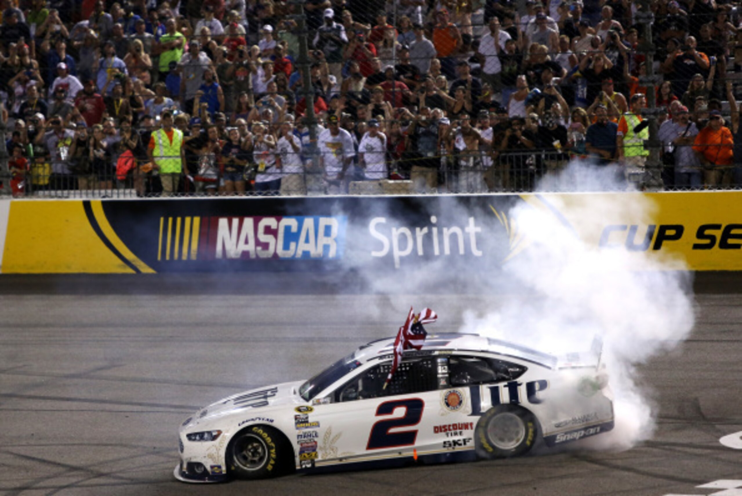 RICHMOND, VA - SEPTEMBER 06:  Brad Keselowski, driver of the #2 Miller Lite Ford, celebrates with a burnout after winning the NASCAR Sprint Cup Series Federated Auto Parts 400 at Richmond International Raceway on September 6, 2014 in Richmond, Virginia.  