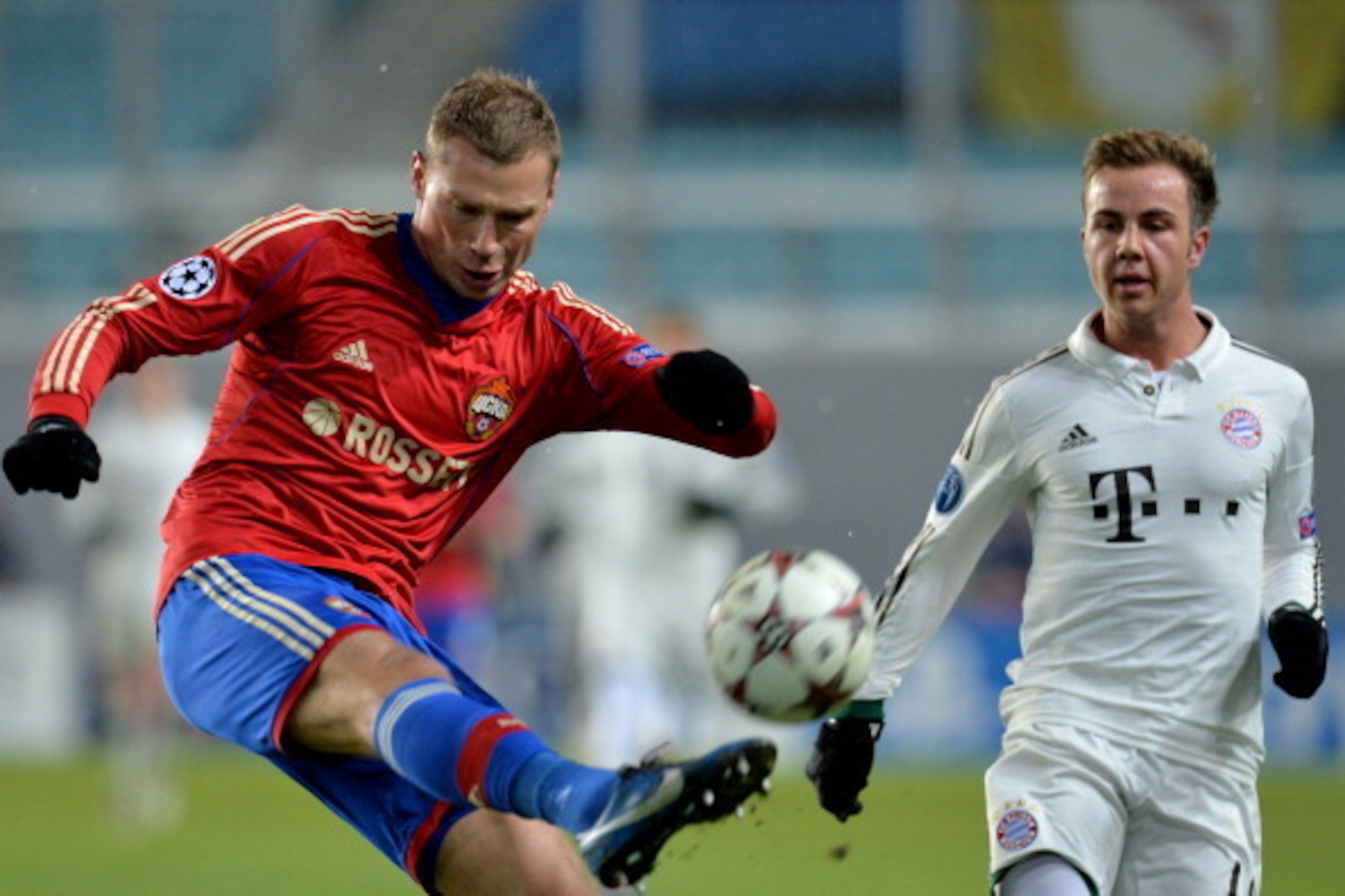 KHIMKI, RUSSIA - NOVEMBER 27: Aleksei Berezutski (L) of PFC CSKA Moscow in action against Mario Gotze of FC Bayern Muenchen during the UEFA Champions League Group D match between PFC CSKA Moscow and FC Bayern Muenchen at the Arena Khimki Stadium on Novemb