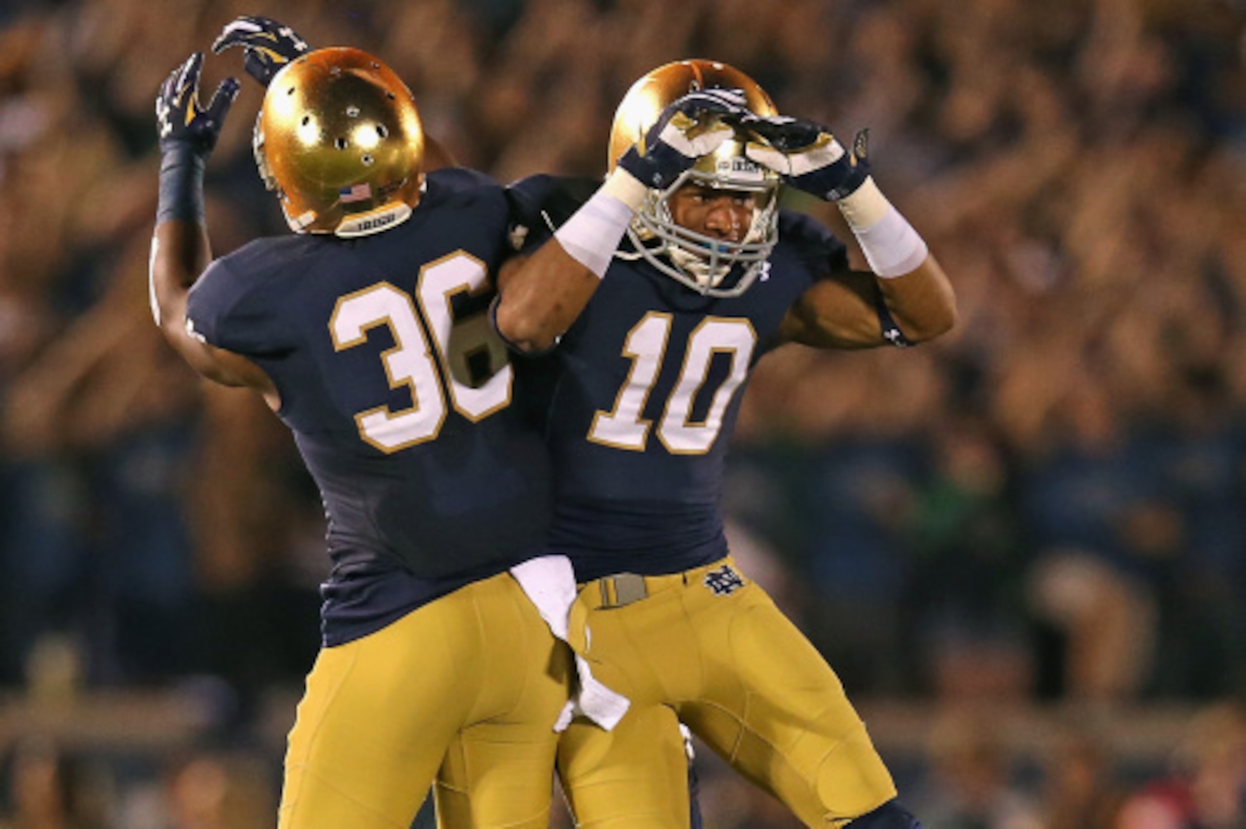 SOUTH BEND, IN - SEPTEMBER 06: Max Redfield #10 and Cole Luke #36 of the Notre Dame Fighting Irish celebrate Redfield's interception against the Michigan Wolverines at Notre Dame Stadium on September 6, 2014 in South Bend, Indiana. (Photo by Jonathan Dani