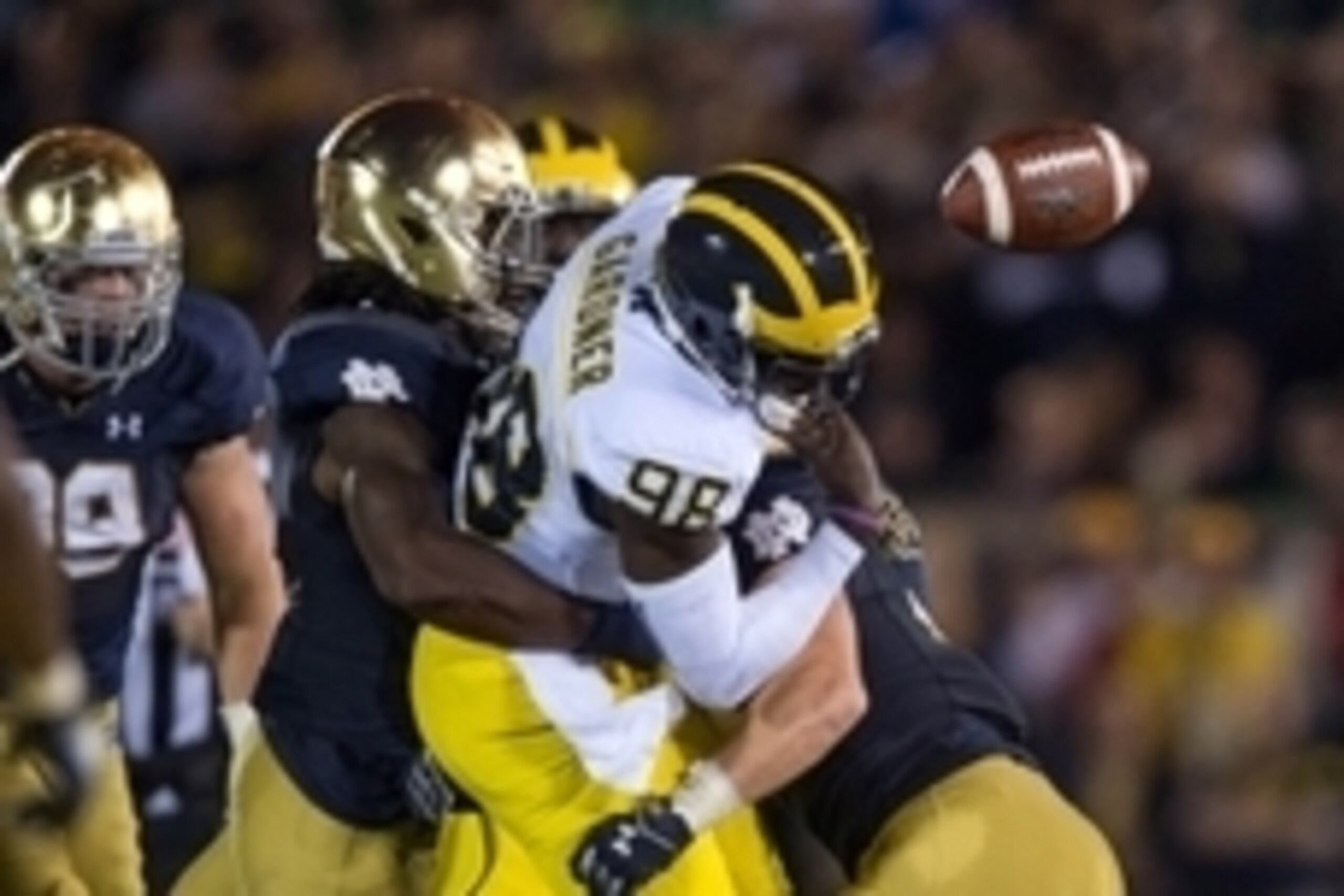 Sep 6, 2014; South Bend, IN, USA; Michigan Wolverines quarterback Devin Gardner (98) fumbles as he is hit by Notre Dame Fighting Irish linebacker Jaylon Smith (9) in the fourth quarter at Notre Dame Stadium. Notre Dame won 31-0. Mandatory Credit: Matt Cas