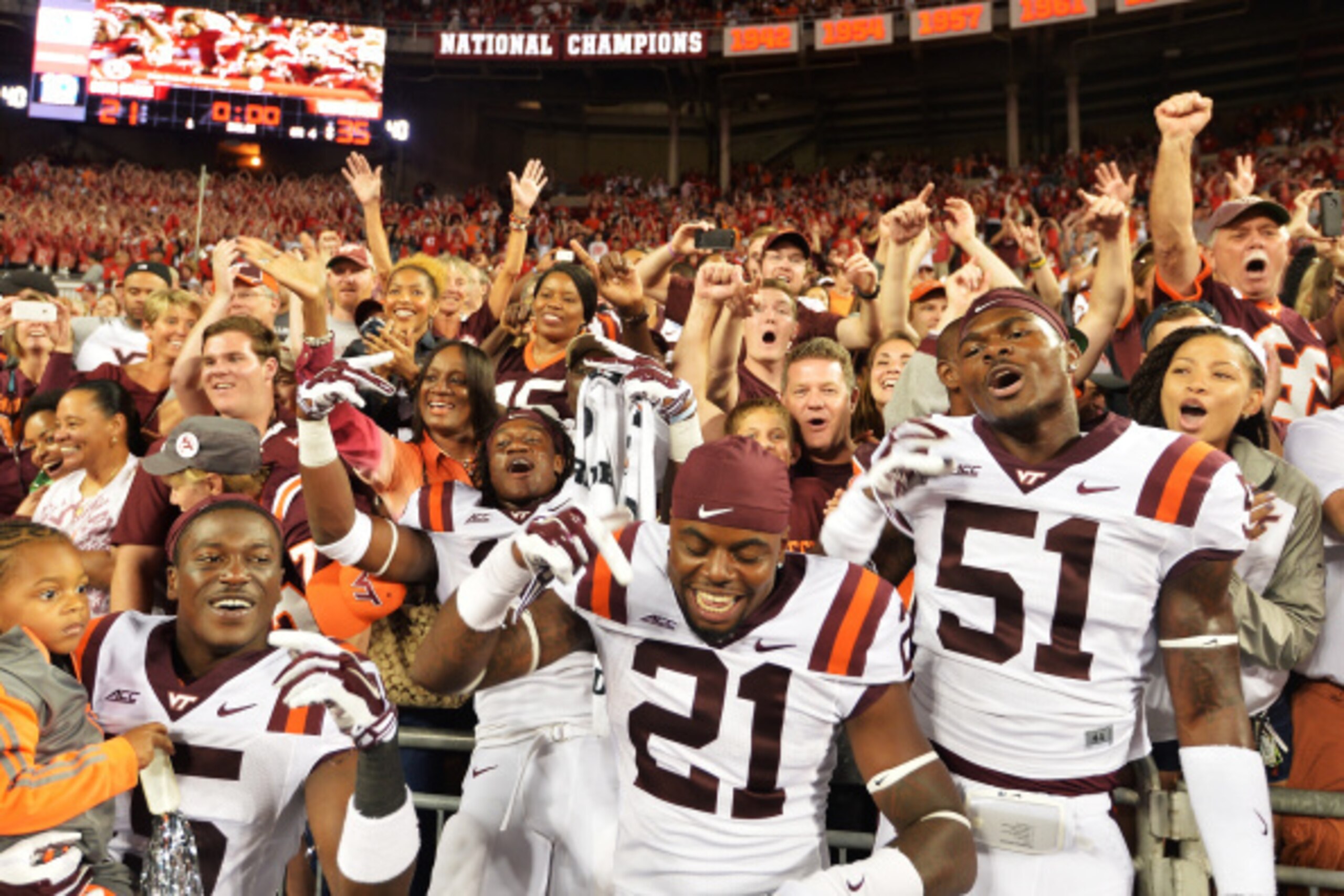 COLUMBUS, OH - SEPTEMBER 6:  C.J. Reavis #21 and Melvin Keihn #51 of the Virginia Tech Hokies celebrate with fans after the Hokies upset the Ohio State Buckeyes 35-21 at Ohio Stadium on September 6, 2014 in Columbus, Ohio.  (Photo by Jamie Sabau/Getty Ima