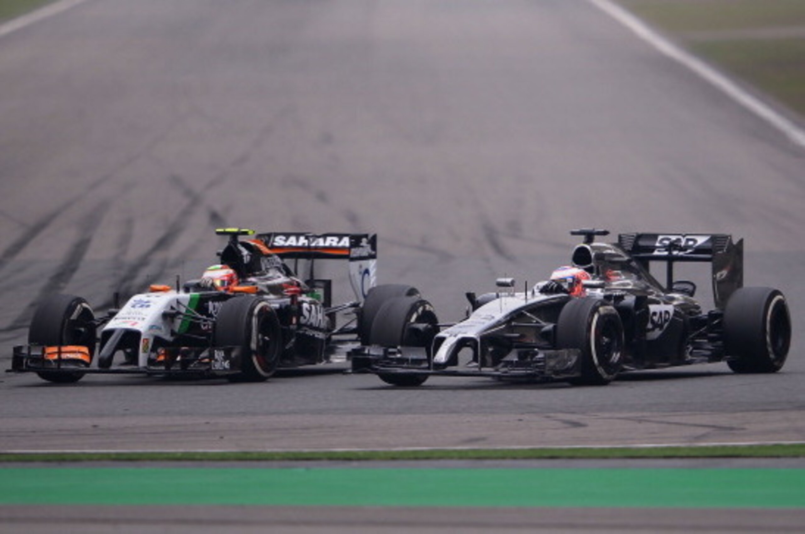 SHANGHAI, CHINA - APRIL 20:  Sergio Perez of Mexico and Force India and Jenson Button of Great Britain and McLaren  compete during the Chinese Formula One Grand Prix at the Shanghai International Circuit on April 20, 2014 in Shanghai, China.  (Photo by La