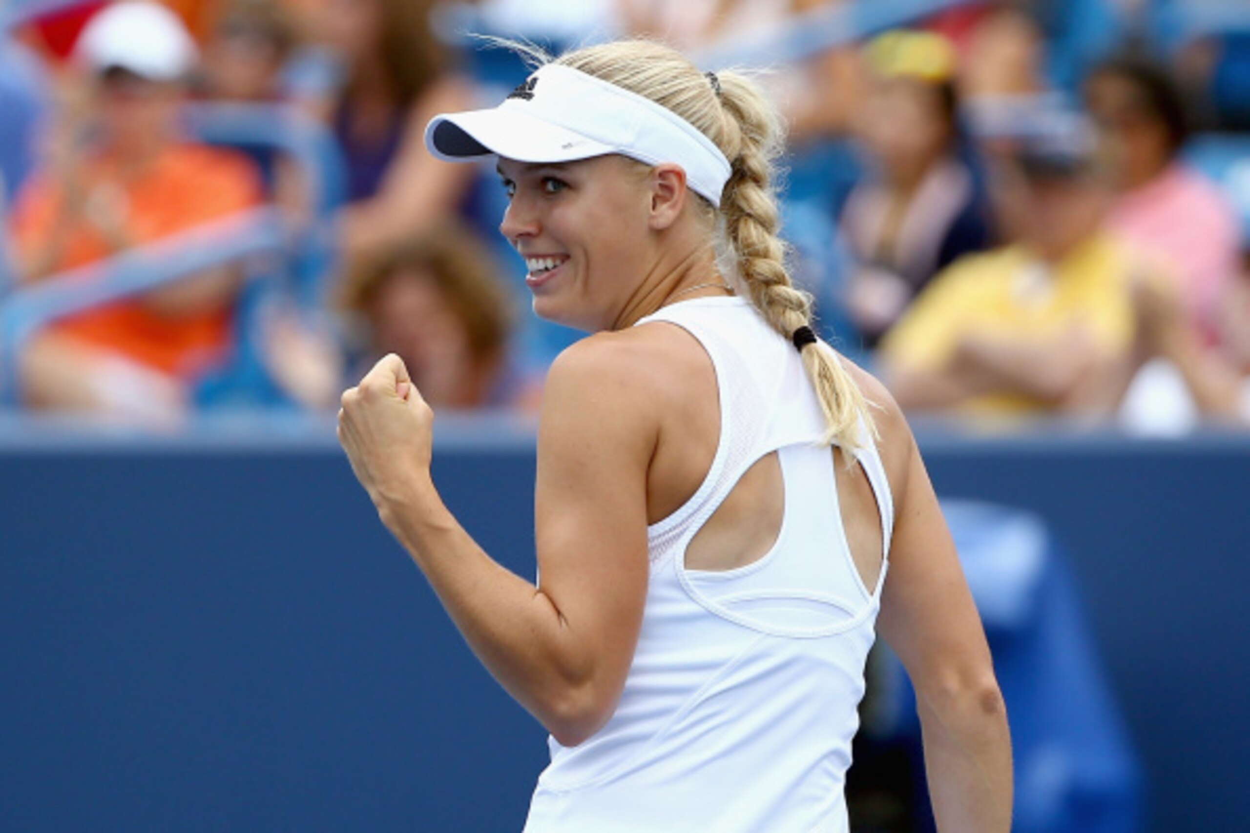 CINCINNATI, OH - AUGUST 16:  Caroline Wozniacki of Denmark celebrates during her match against Serena Williams on day 8 of the Western & Southern Open on August 16, 2014 at the Linder Family Tennis Center in Cincinnati, Ohio.  (Photo by Andy Lyons/Getty I
