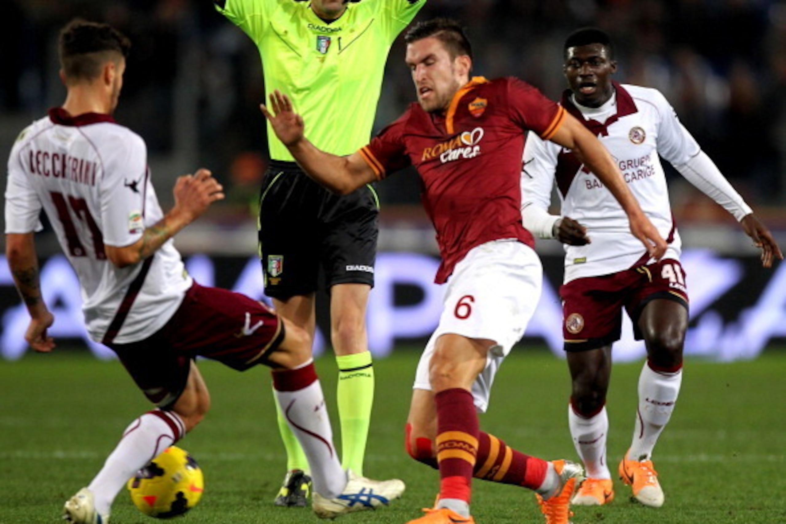 ROME, ITALY - JANUARY 18:  Kevin Strootman (C) of AS Roma competes for the ball with Federico Ceccherini of AS Livorno during the Serie A match between AS Roma and AS Livorno Calcio at Stadio Olimpico on January 18, 2014 in Rome, Italy.  (Photo by Paolo B