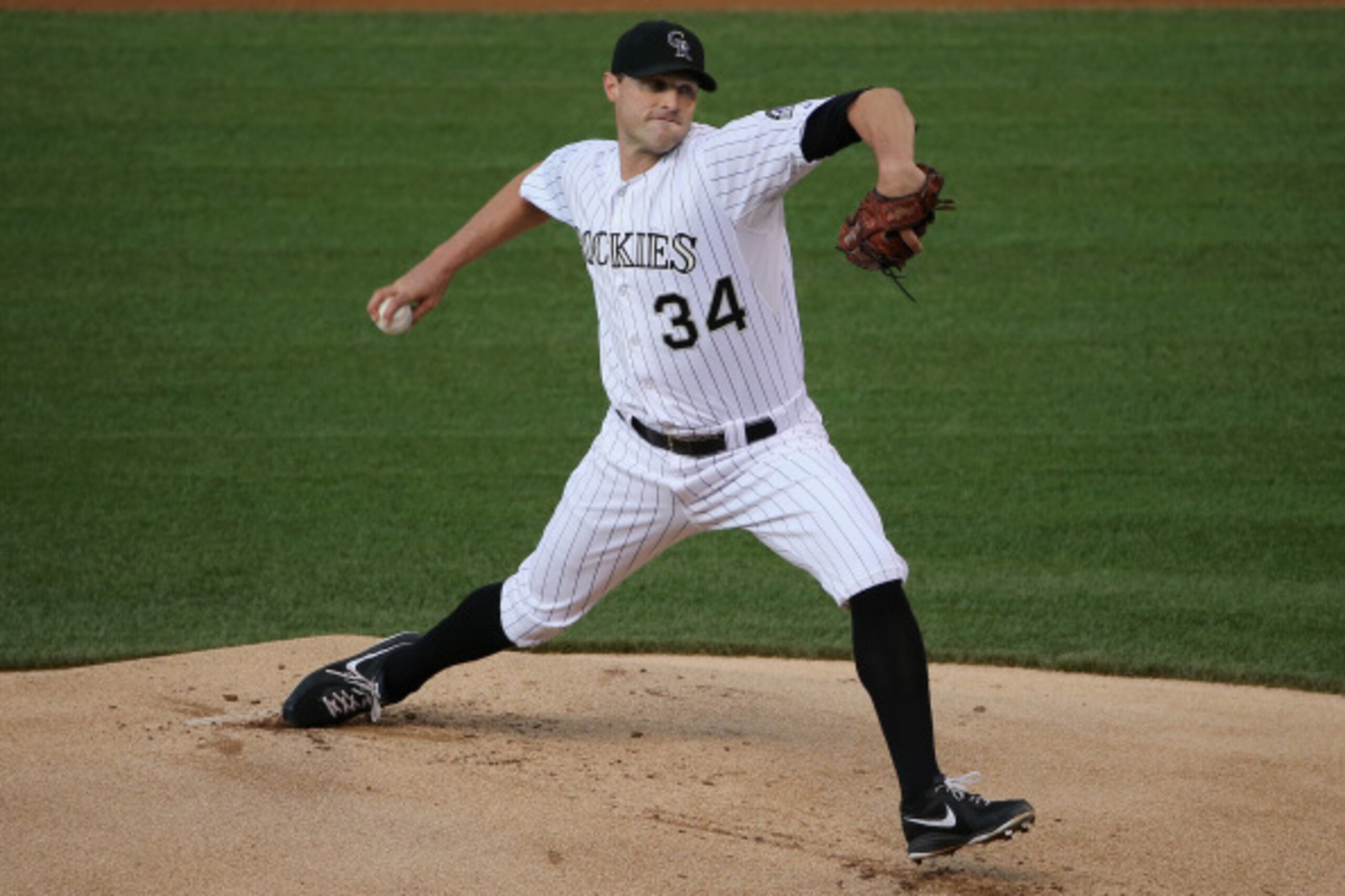 DENVER, CO - AUGUST 15:  Starting pitcher Matt Belisle #34 of the Colorado Rockies delivers against the Cincinnati Reds at Coors Field on August 15, 2014 in Denver, Colorado.  (Photo by Doug Pensinger/Getty Images)
