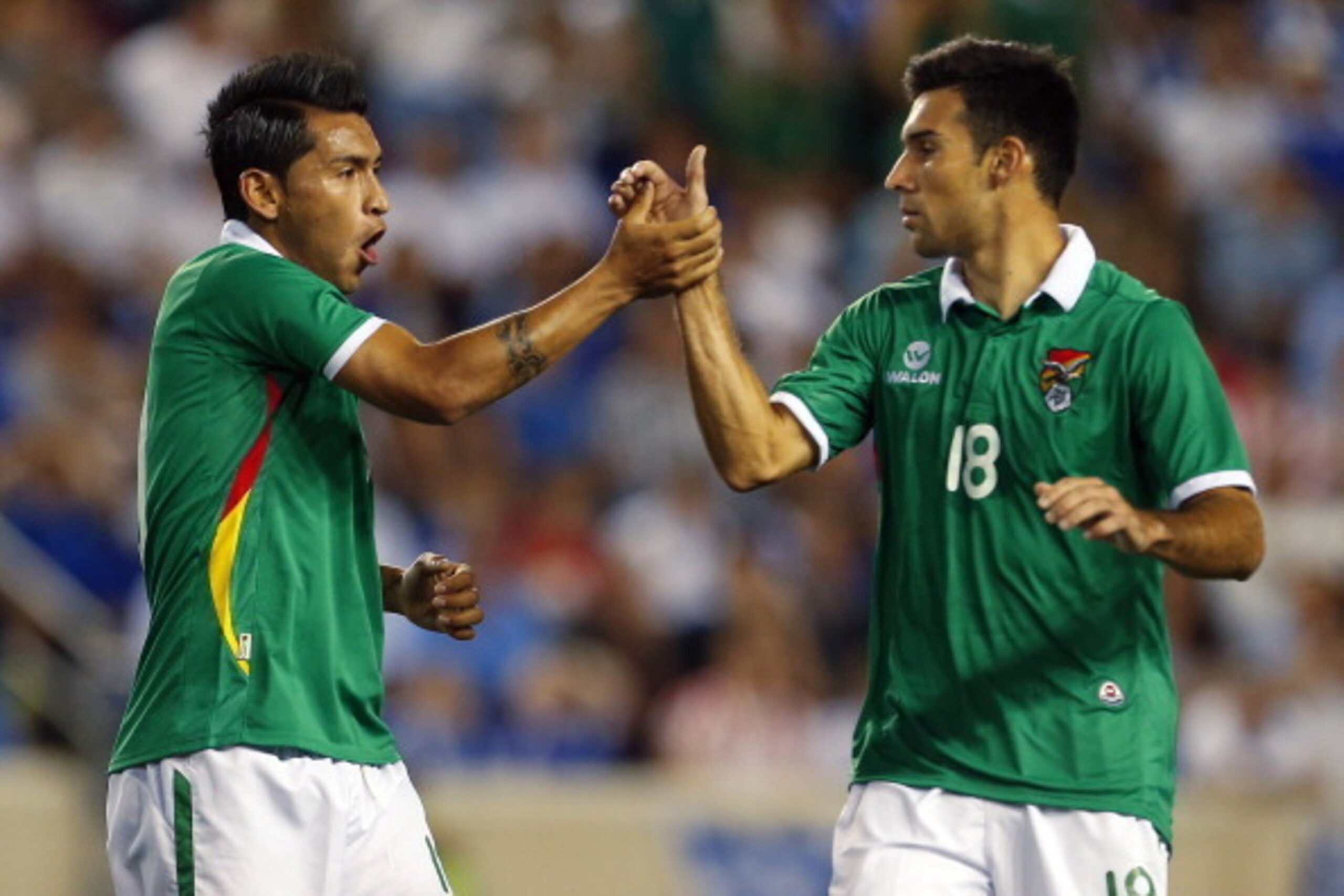 HARRISON, NJ - JUNE 6: Rudy Cardozo #10 of Bolivia (L) is congratulated by teammate Danny Bejarano #18 after scoring a goal during the second half of an international friendly match against Greece at Red Bull Arena on June 6, 2014 in Harrison, New Jersey.