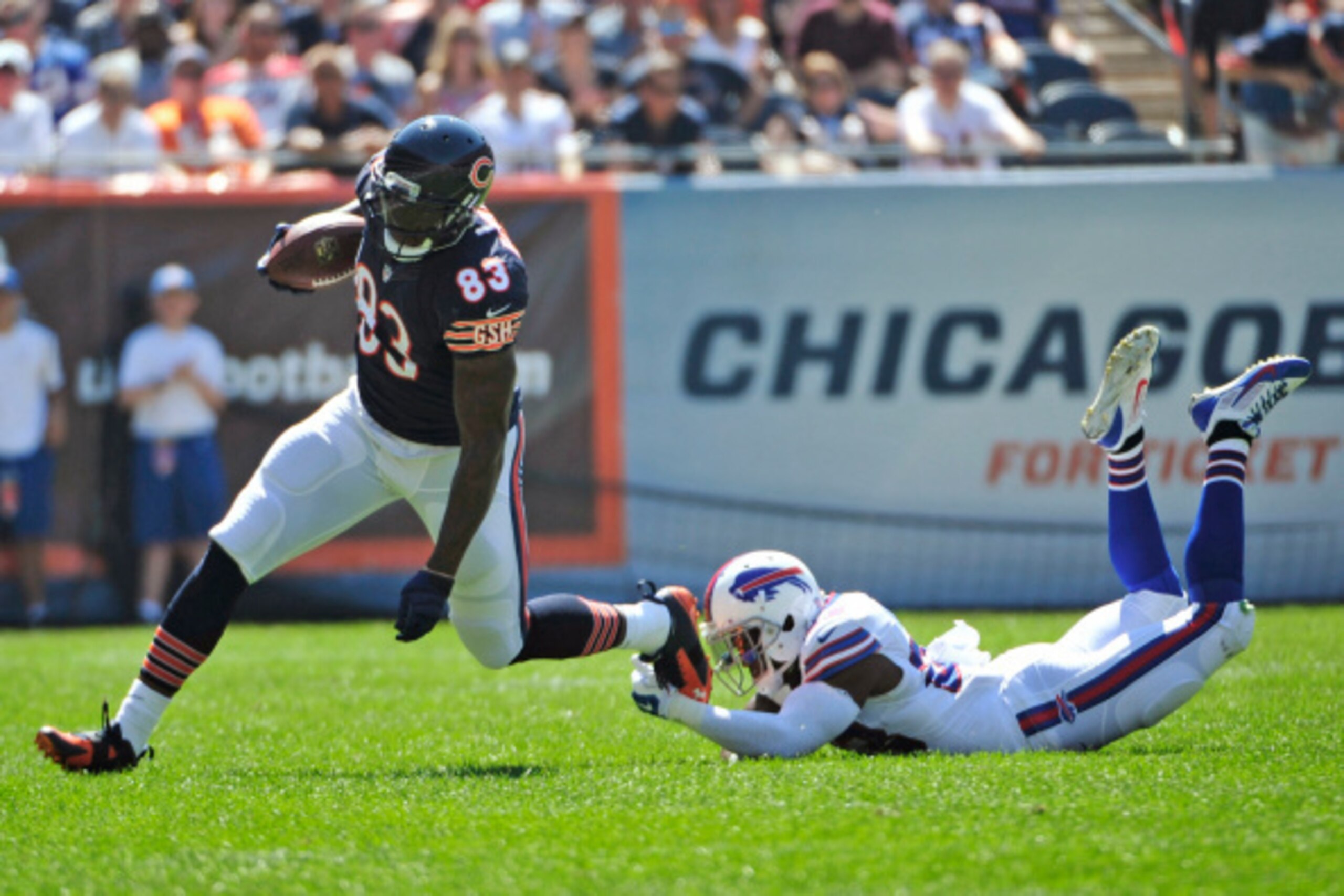 CHICAGO, IL - SEPTEMBER 07: Martellus Bennett #83 of the Chicago Bears avoids a tackle by Aaron Williams #23 of the Buffalo Bills during the first half of their game on September 7, 2014 at Soldier Field in Chicago, Illinois.  (Photo by David Banks/Getty 