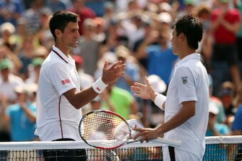 NEW YORK, NY - SEPTEMBER 06:  Kei Nishikori of Japan greats Novak Djokovic (L) of Serbia after their men's singles semifinal match on Day Thirteen of the 2014 US Open at the USTA Billie Jean King National Tennis Center on September 6, 2014 in the Flushing