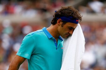 NEW YORK, NY - SEPTEMBER 06:  Roger Federer of Switzerland wipes his face while playing against Marin Cilic of Croatia during their men's singles semifinal match on Day Thirteen of the 2014 US Open at the USTA Billie Jean King National Tennis Center on Se