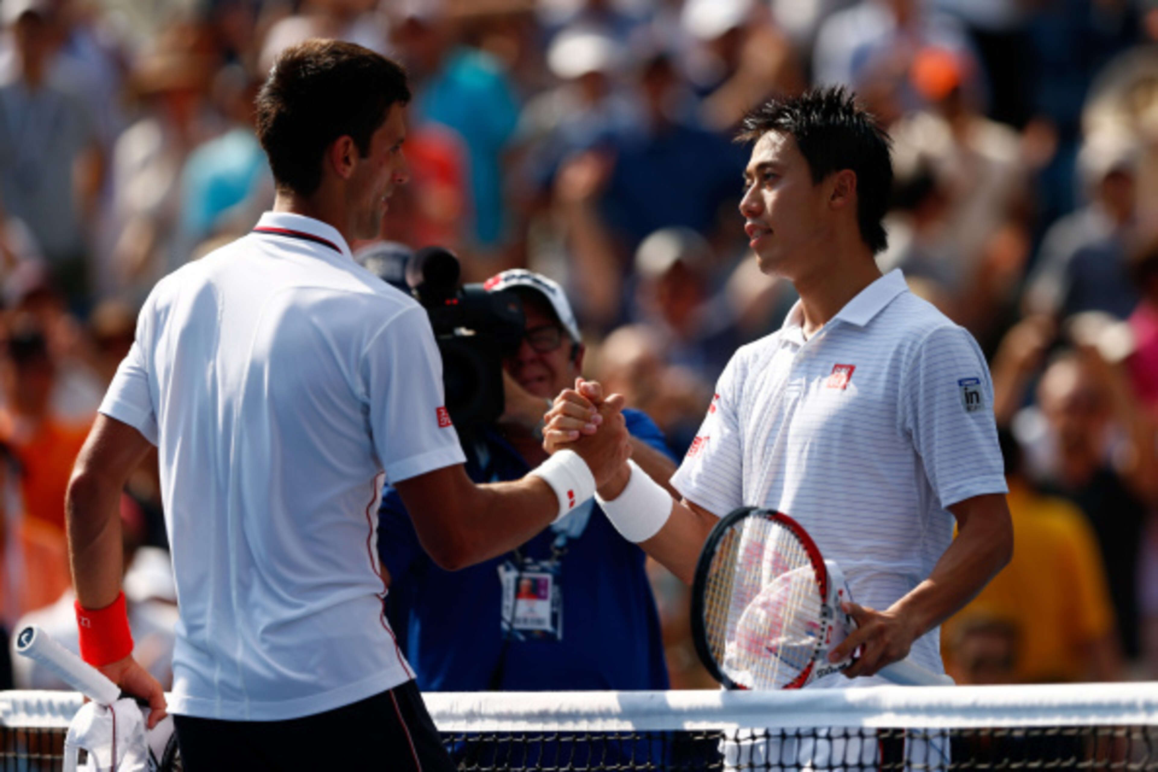 NEW YORK, NY - SEPTEMBER 06:  Kei Nishikori of Japan greats Novak Djokovic (L) of Serbia after their men's singles semifinal match on Day Thirteen of the 2014 US Open at the USTA Billie Jean King National Tennis Center on September 6, 2014 in the Flushing