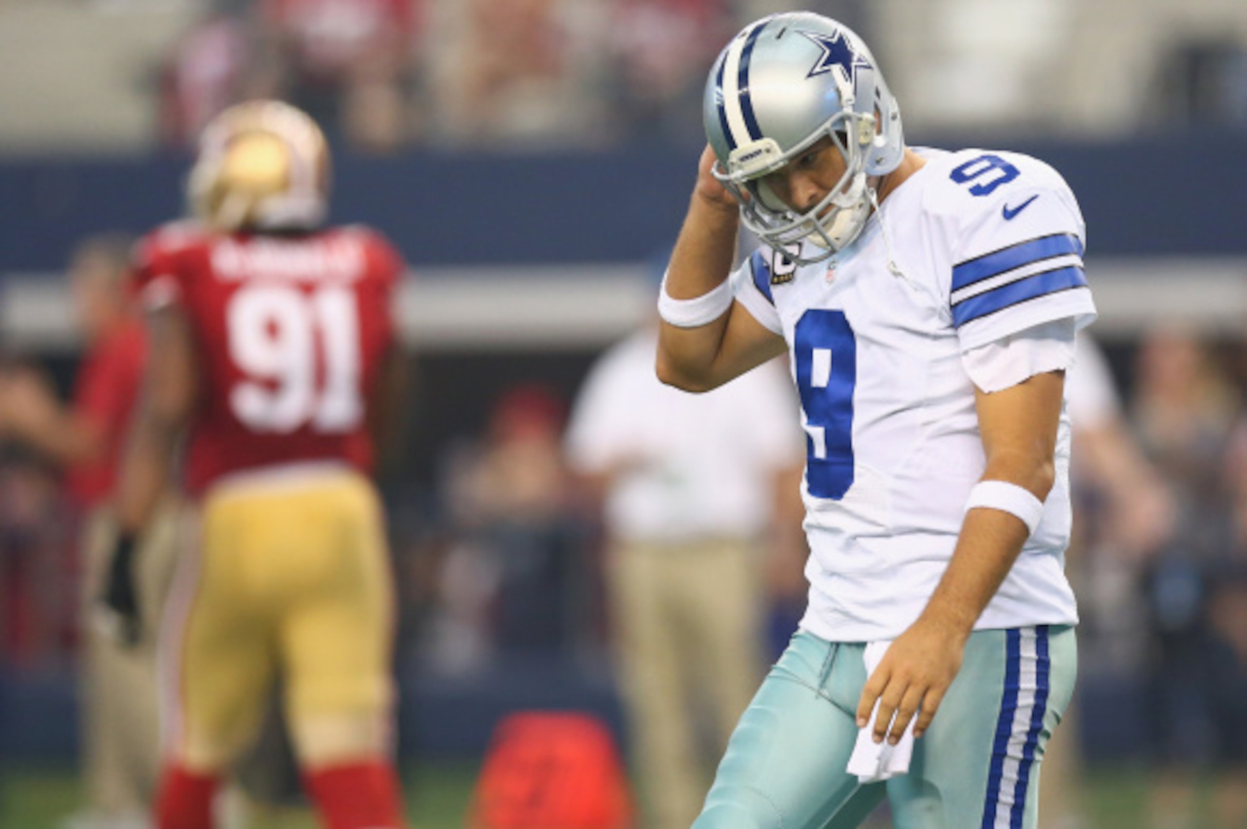 ARLINGTON, TX - SEPTEMBER 07:  Tony Romo #9 of the Dallas Cowboys walks off the field after throwing a interception against the San Francisco 49ers in the second quarter at AT&T Stadium on September 7, 2014 in Arlington, Texas.  (Photo by Ronald Martinez/