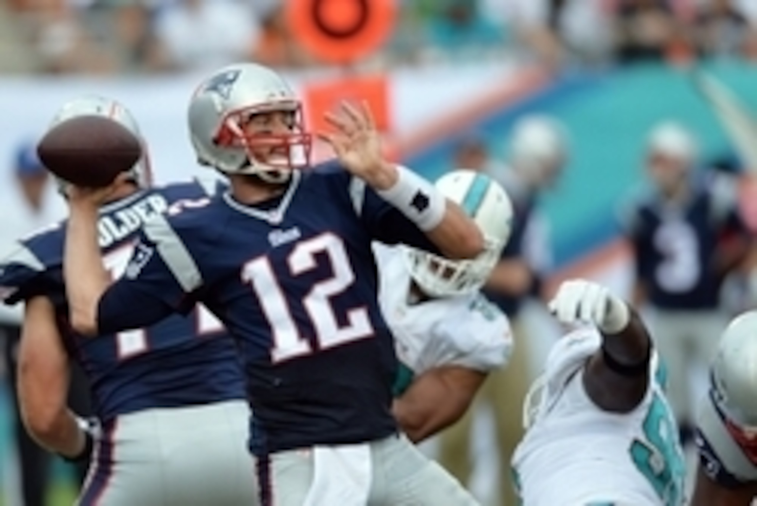 Sep 7, 2014; Miami Gardens, FL, USA; New England Patriots quarterback Tom Brady (12) throws against the Miami Dolphins defense during the first half at Sun Life Stadium. Mandatory Credit: Steve Mitchell-USA TODAY Sports Sep 7, 2014; Miami Gardens, FL, USA; New England Patriots quarterback Tom Brady (12) throws against the Miami Dolphins defense during the first half at Sun Life Stadium. Mandatory Credit: Steve Mitchell-USA TODAY Sports