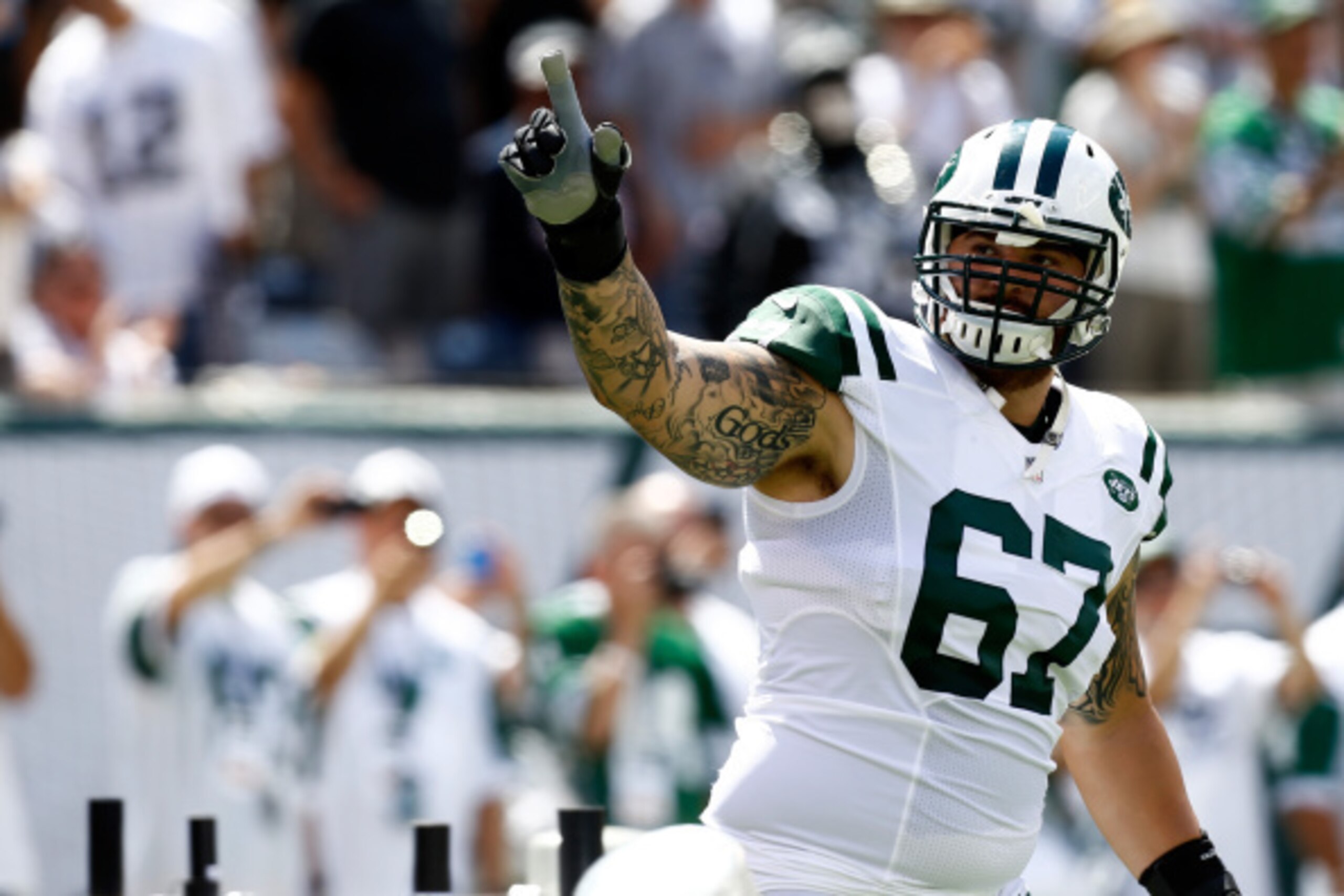 EAST RUTHERFORD, NJ - SEPTEMBER 07:   Brian Winters #67 of the New York Jets is introduced before a game against the Oakland Raiders at MetLife Stadium on September 7, 2014 in East Rutherford, New Jersey.  (Photo by Jeff Zelevansky/Getty Images)
