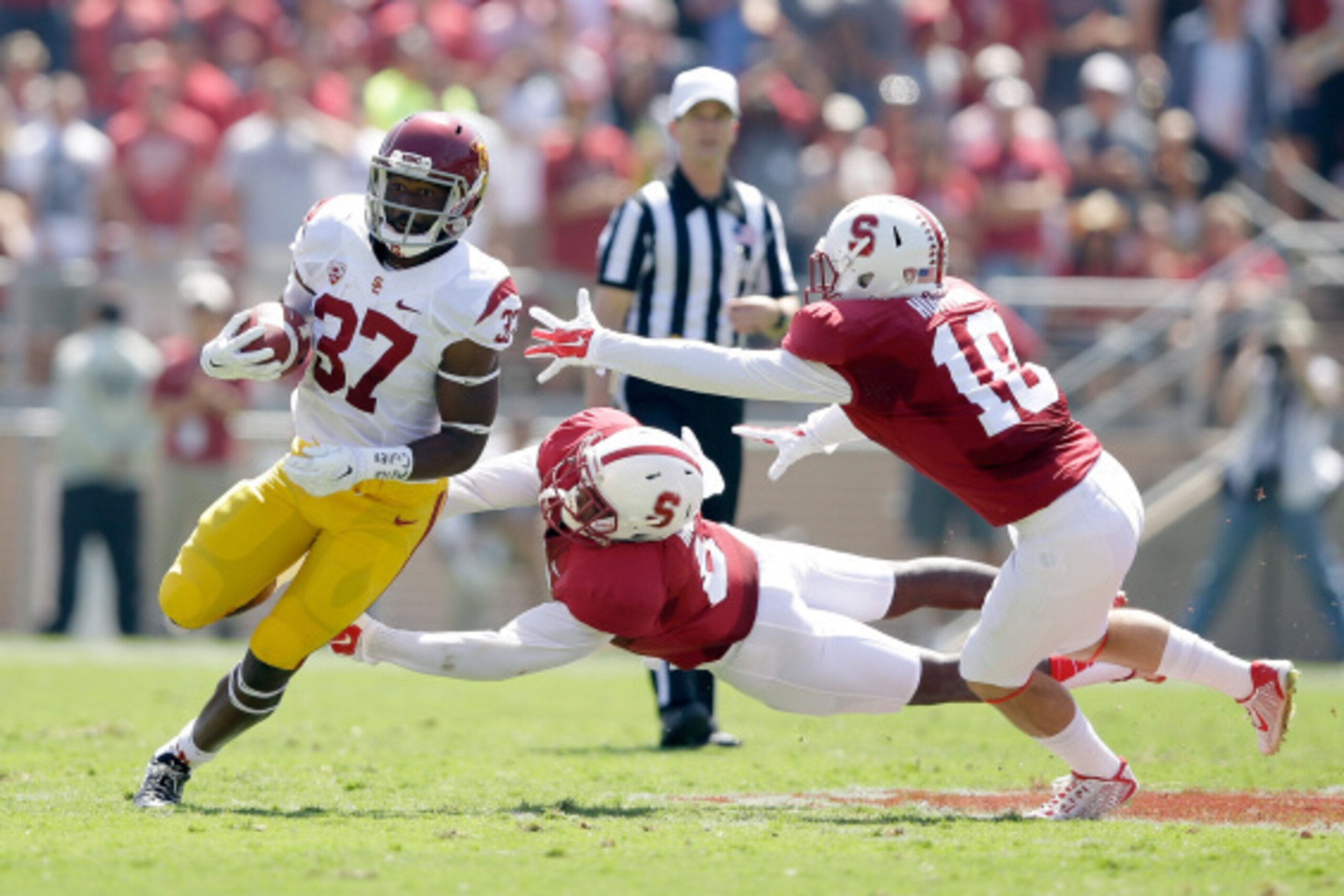PALO ALTO, CA - SEPTEMBER 06: Javorius Allen #37 of the USC Trojans tries to run away from Jordan Richards #8 and Zach Hoffpauir #10 of the Stanford Cardinal at Stanford Stadium on September 6, 2014 in Palo Alto, California. (Photo by Ezra Shaw/Getty Im PALO ALTO, CA - SEPTEMBER 06: Javorius Allen #37 of the USC Trojans tries to run away from Jordan Richards #8 and Zach Hoffpauir #10 of the Stanford Cardinal at Stanford Stadium on September 6, 2014 in Palo Alto, California. (Photo by Ezra Shaw/Getty Im