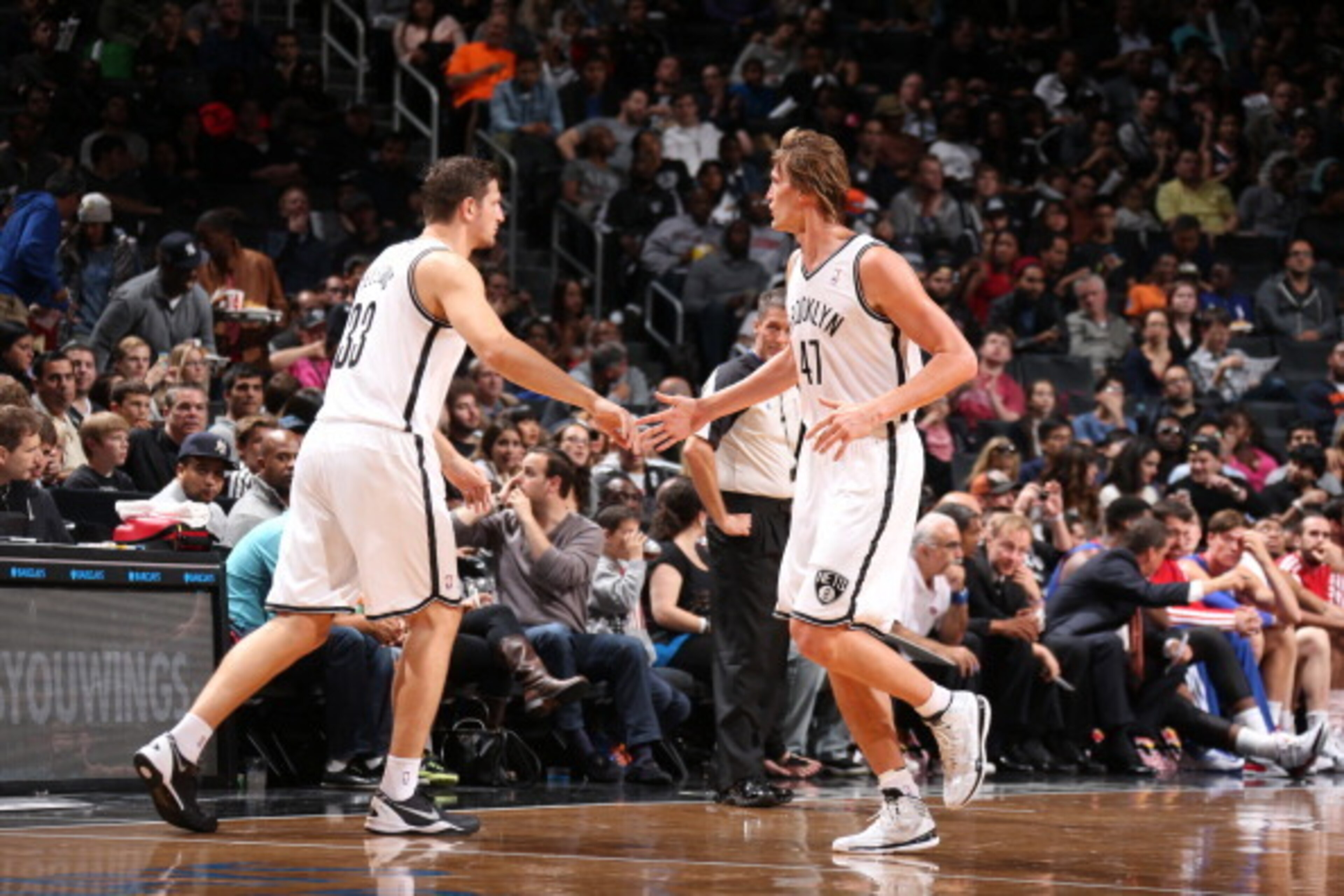 NEW YORK, NY - OCTOBER 12:  Mirza Teletovic #33 and Andrei Kirilenko #47 of the Brooklyn Nets shake hands against the Detroit Pistons during a preseason game at the Barclays Center on October 12, 2013 in the Brooklyn borough of New York City.  NOTE TO USE