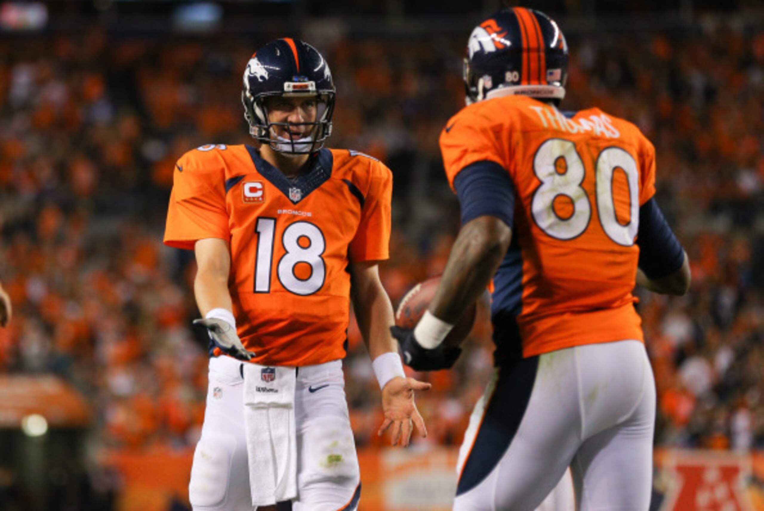 DENVER, CO - SEPTEMBER 7:  Quarterback Peyton Manning #18 of the Denver Broncos and tight end Julius Thomas #80 celebrate Thomas' third touchdown reception of the first half of a game at Sports Authority Field at Mile High on September 7, 2014 in Denver,