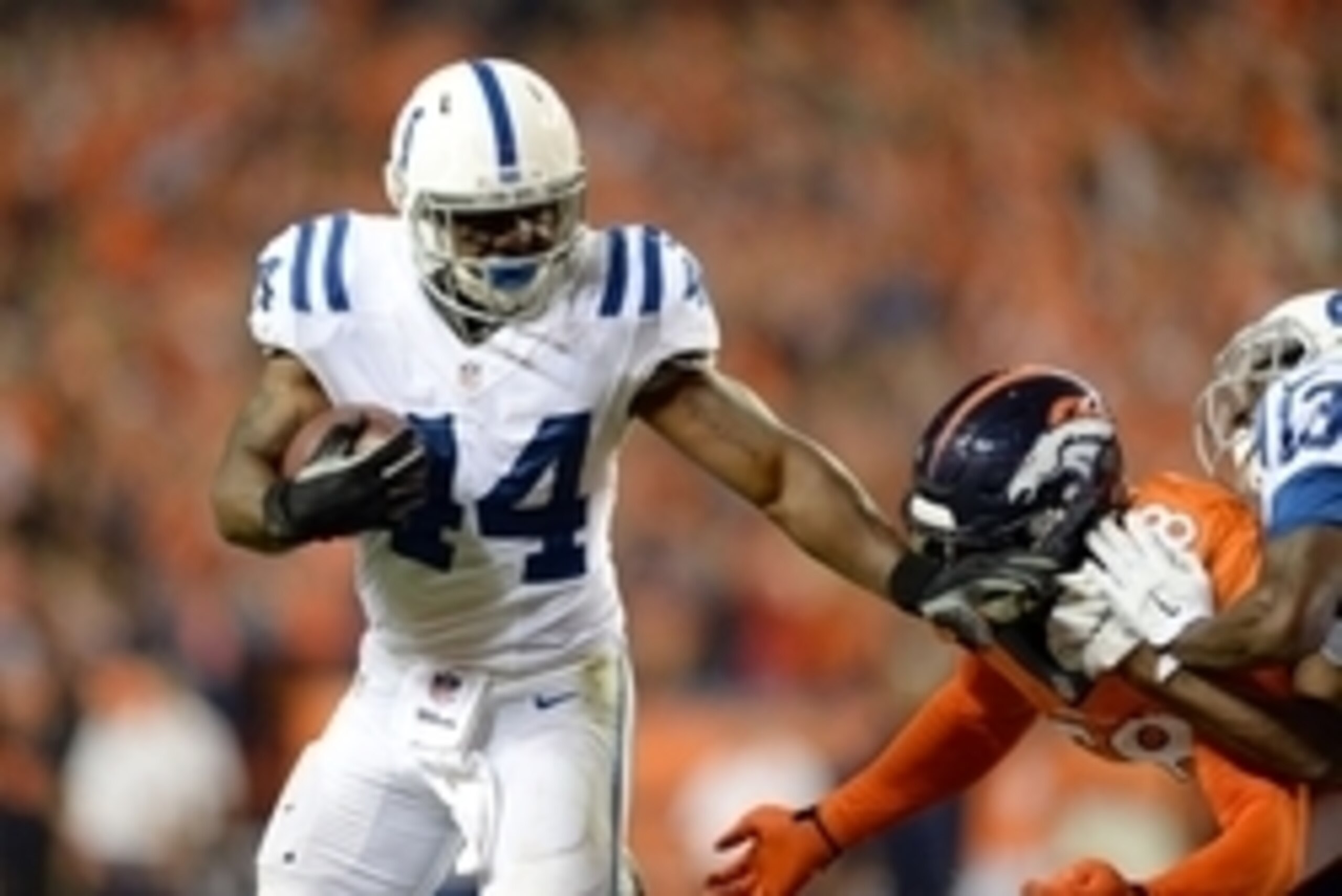 Sep 7, 2014; Denver, CO, USA; Indianapolis Colts running back Ahmad Bradshaw (44) stiff arms Denver Broncos outside linebacker Von Miller (58) in the third quarter at Sports Authority Field at Mile High. The Broncos defeated the Colts 31-24. Mandatory Cre