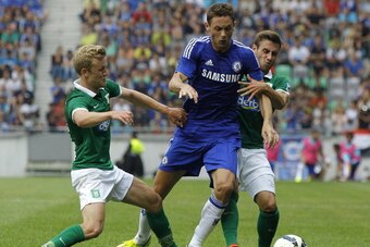 LJUBLJANA, SLOVENIA - JULY 27: Nemanja Matic (C) of Chelsea is challenged by Nik Omladic (L) of Olimpija Ljubljana (R) the Pre Season Friendly  match between FC Olimpija Ljubljana and Chelsea at Stozice stadium in Ljubljana, Slovenia on Sunday, July 27, 2