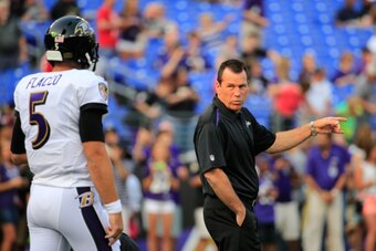 BALTIMORE, MD - AUGUST 07:  Quarterback Joe Flacco #5 of the Baltimore Ravens talks with offensive coordinator Gary Kubiak before the start of their game against the San Francisco 49ers durng an NFL pre-season game at M&T Bank Stadium on August 7, 2014 in