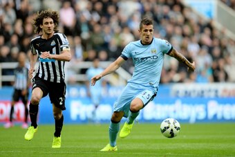 NEWCASTLE UPON TYNE, ENGLAND - AUGUST 17:  Stevan Jovetic of Manchester City is pursued by Fabricio Coloccini of Newcastle during the Barclays Premier League match between Newcastle United and Manchester City at St James' Park on August 17, 2014 in Newcas