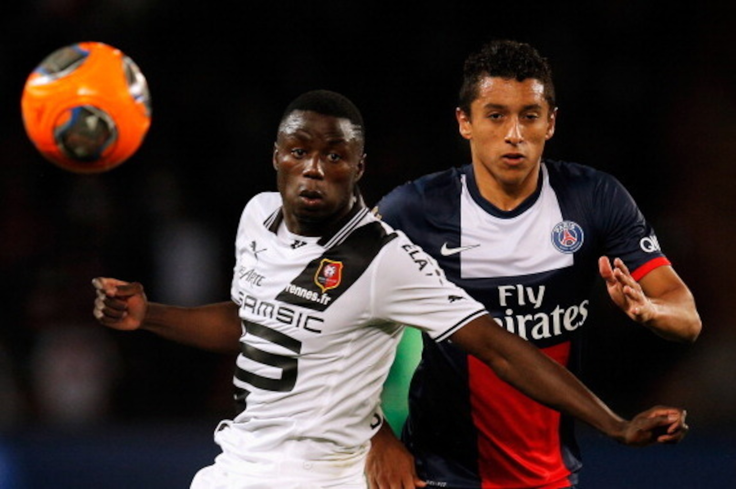 PARIS, FRANCE - MAY 07:  Marquinhos of PSG and Paul-Georges Ntep de Madiba of Rennais battle for the ball during the Ligue 1 match between Paris Saint-Germain FC and Stade Rennais FC at Parc des Princes on May 7, 2014 in Paris, France.  (Photo by Dean Mou