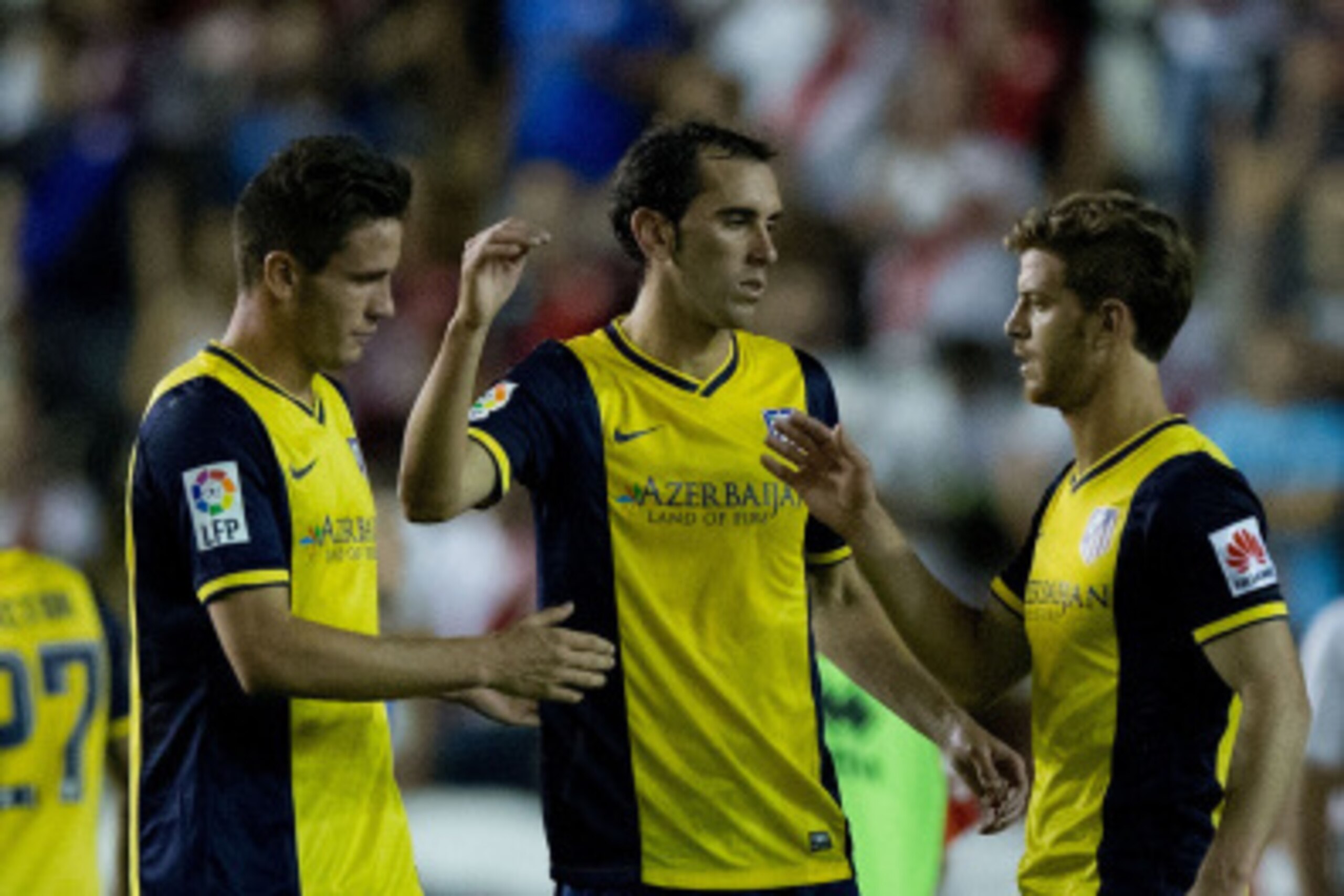MADRID, SPAIN - AUGUST 25: Diego Godin (2ndL) of Atletico de Madrid shake hands with teammates Cristian Ansaldi (R) and Saul Niguez (L) after the La Liga match between Rayo Vallecano de Madrid and Club Atletico de Madrid at Estadio de Vallecas on August 2