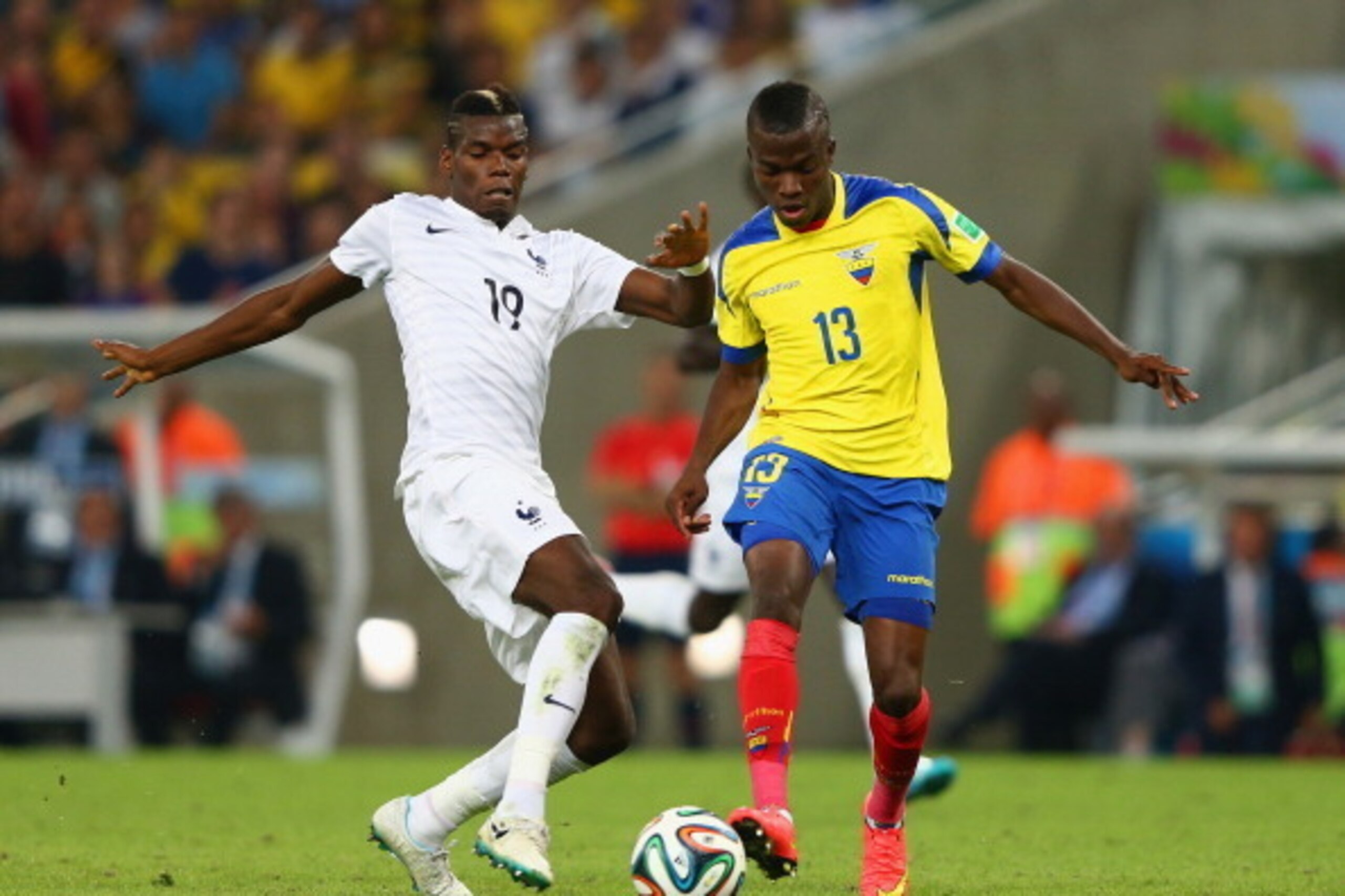 RIO DE JANEIRO, BRAZIL - JUNE 25: Paul Pogba of France challenges Enner Valencia of Ecuador during the 2014 FIFA World Cup Brazil Group E match between Ecuador and France at Maracana on June 25, 2014 in Rio de Janeiro, Brazil.  (Photo by Jamie Squire/Gett