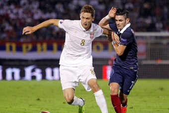 BELGRADE, SERBIA - SEPTEMBER 07: Nemanja Matic (R) of Serbia is challenged by Remy Cabella (R) of France  during the International friendly match between Serbia and France at the Stadium JNA on September 07, 2014 in Belgrade, Serbia, 2014. (Photo by Srdja