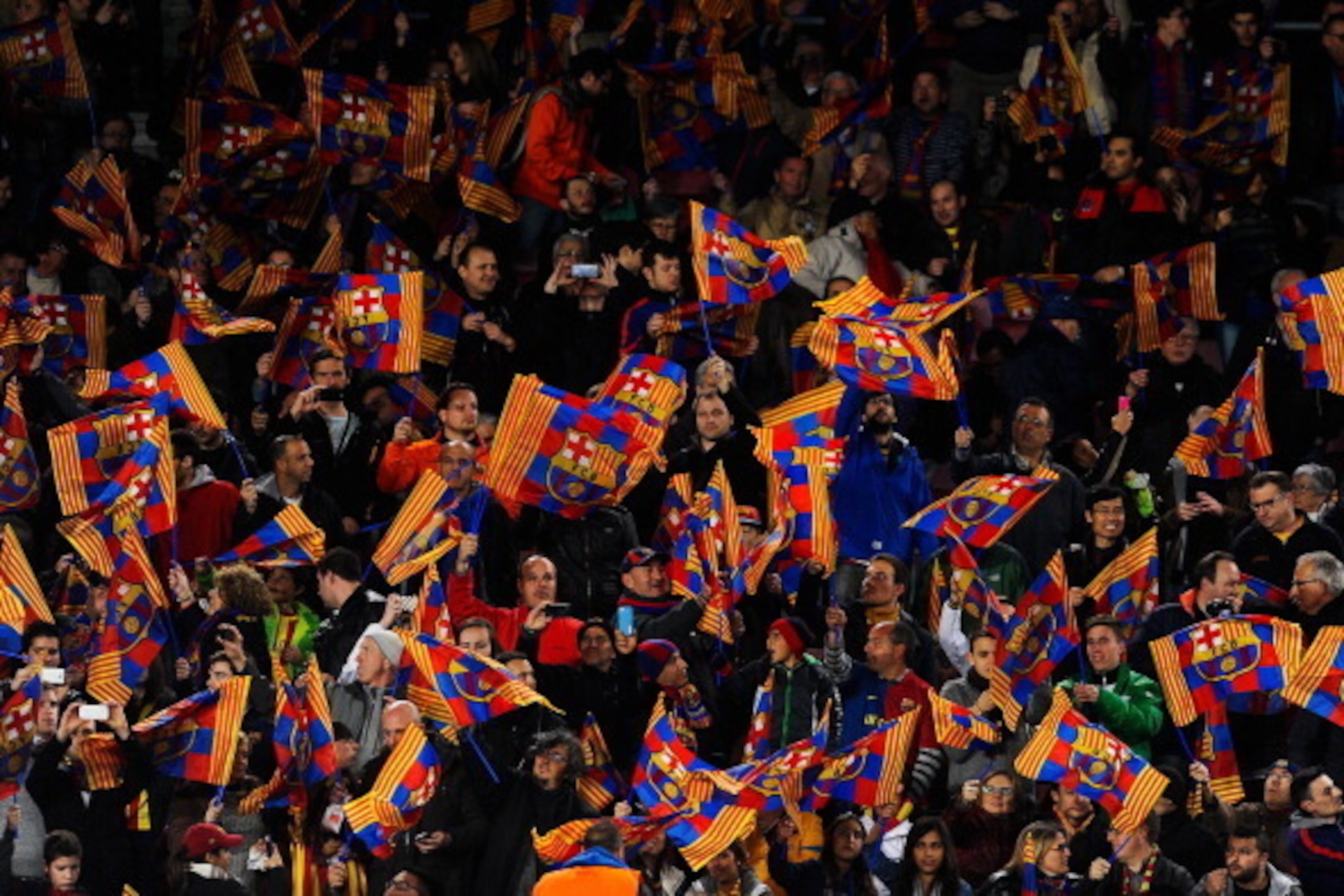BARCELONA, SPAIN - MARCH 12:  FC Barcelona supporters wave flags prior to the UEFA Champions League Round of 16 second leg match between FC Barcelona and Manchester City at Camp Nou on March 12, 2014 in Barcelona, Spain.  (Photo by David Ramos/Getty Image