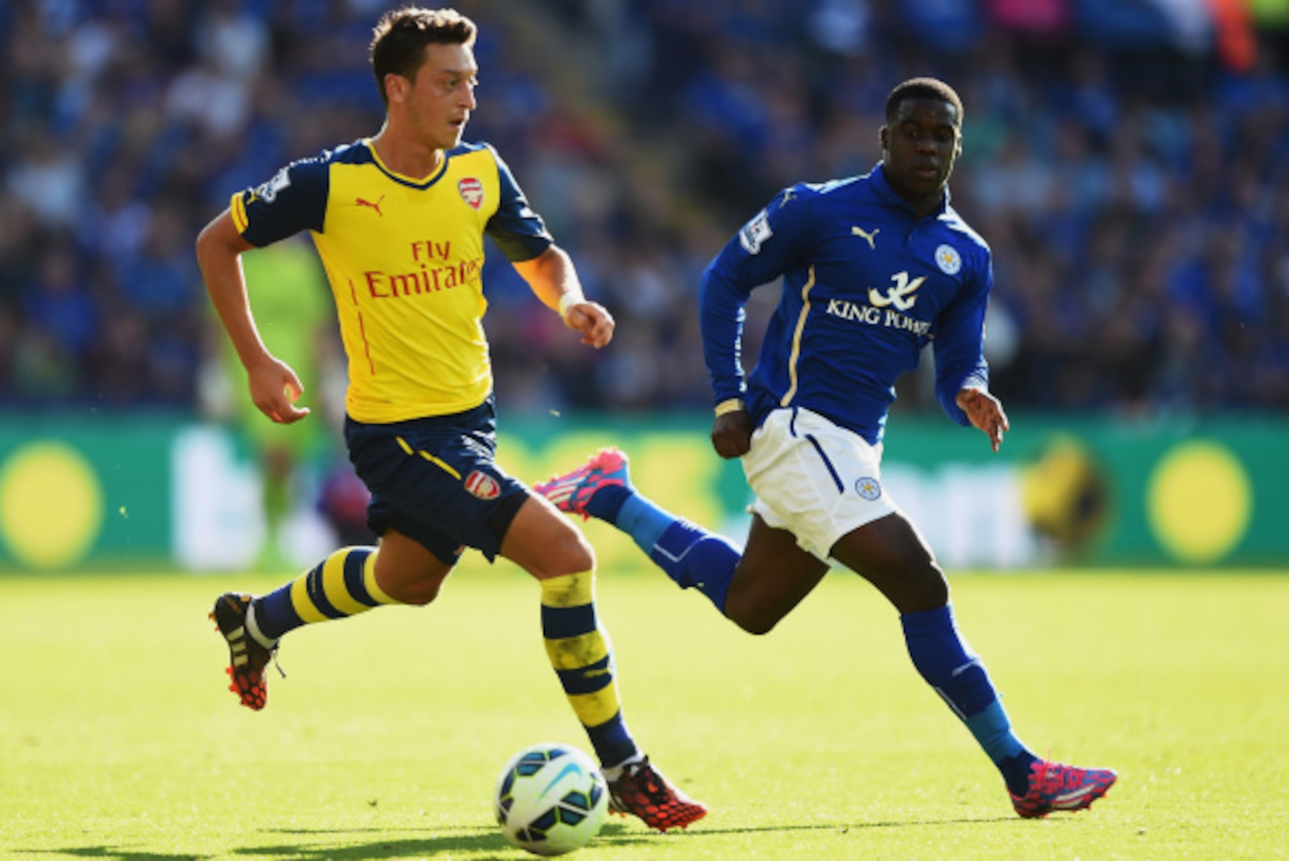 LEICESTER, ENGLAND - AUGUST 31:  Mesut Oezil of Arsenal is closed down by Jeffrey Schlupp of Leicester City during the Barclays Premier League match between Leicester City and Arsenal at The King Power Stadium on August 31, 2014 in Leicester, England.  (P