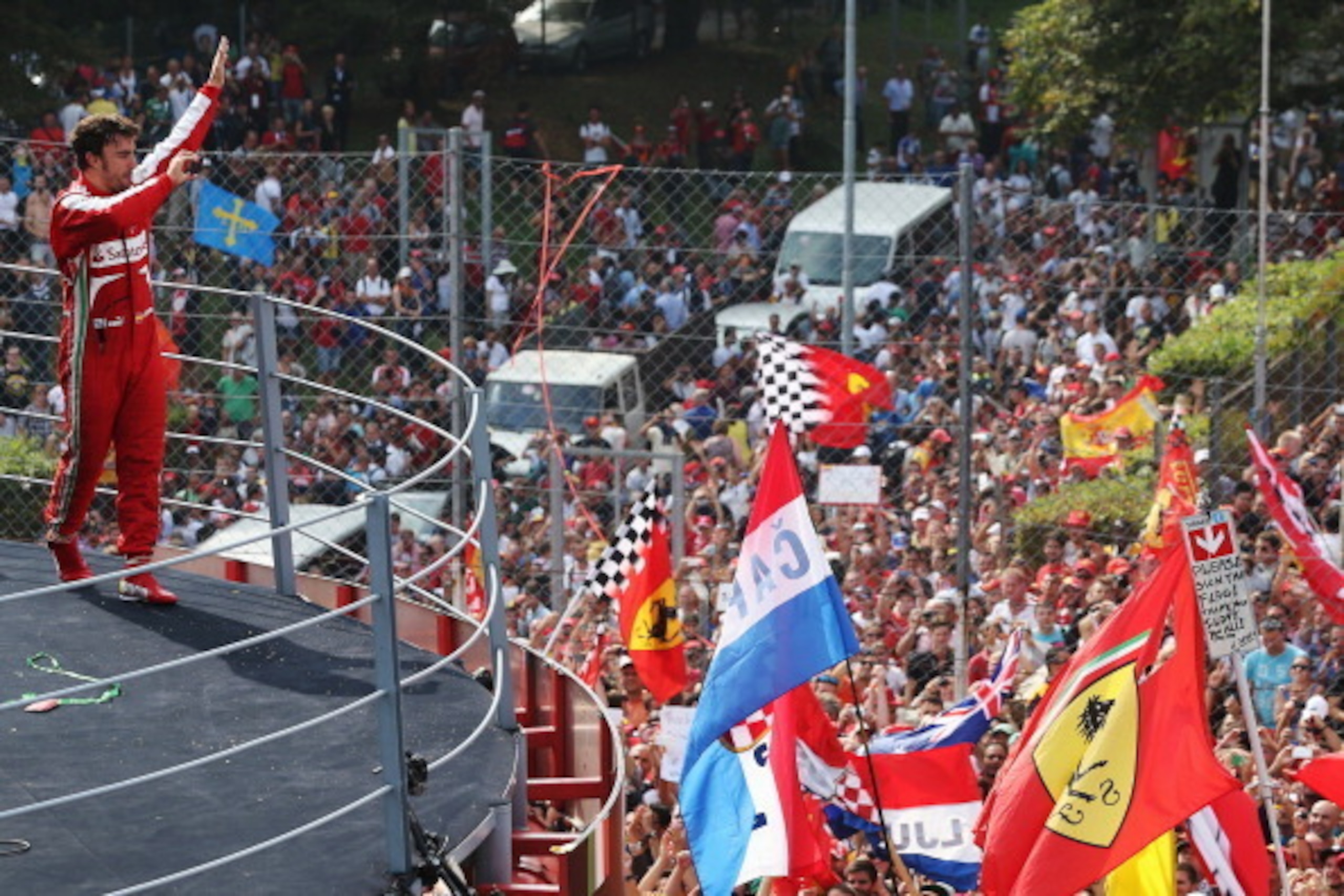 MONZA, ITALY - SEPTEMBER 08:  Fernando Alonso of Spain and Ferrari celebrates on the podium after finishing second during the Italian Formula One Grand Prix at Autodromo di Monza on September 8, 2013 in Monza, Italy.  (Photo by Mark Thompson/Getty Images)