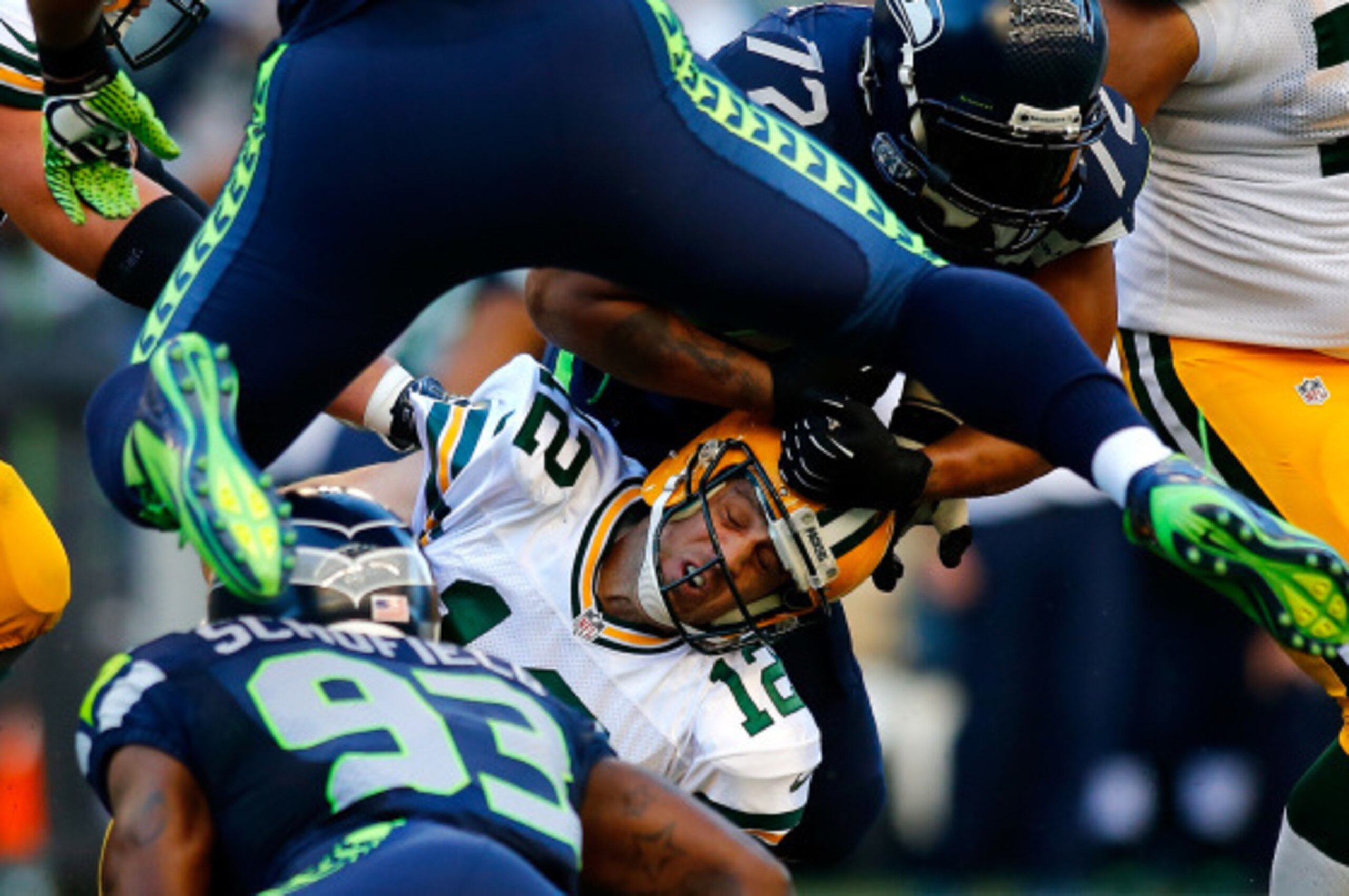 SEATTLE - SEPTEMBER 04:  Quarterback Aaron Rodgers #12 of the Green Bay Packers is sacked by Michael Bennett #72 of the Seattle Seahawks at Century Link Field on September 4, 2014 in Seattle, Washington.  (Photo by Jonathan Ferrey/Getty Images)