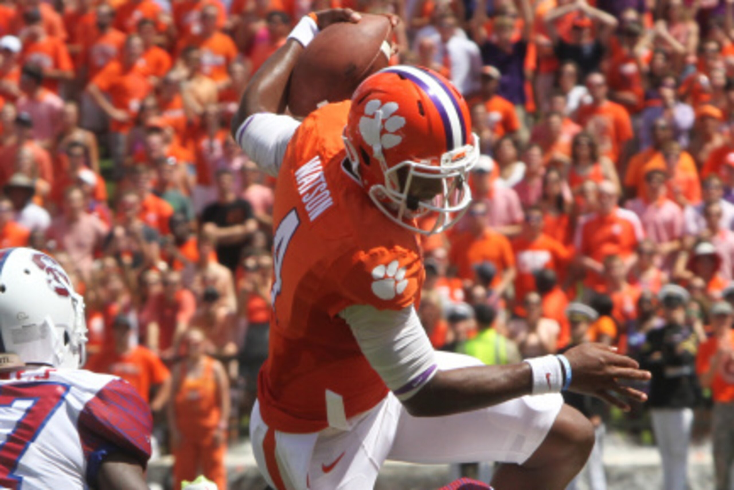 CLEMSON, SC - SEPTEMBER 6: Quarterback Deshaun Watson #4 of the Clemson Tigers hurtles over free safety Mariel Cooper #20 of the South Carolina State Bulldogs on September 6, 2014 at Memorial Stadium in Clemson,  South Carolina.  (Photo by Mary Ann Chasta
