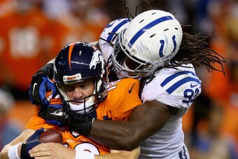 DENVER, CO - SEPTEMBER 07:  Quarterback  Peyton Manning #18 of the Denver Broncos is sacked by Erik Walden #93 of the Indianapolis Colts in the fourth quarter at Sports Authority Field at Mile High on September 7, 2014 in Denver, Colorado. The Broncos def