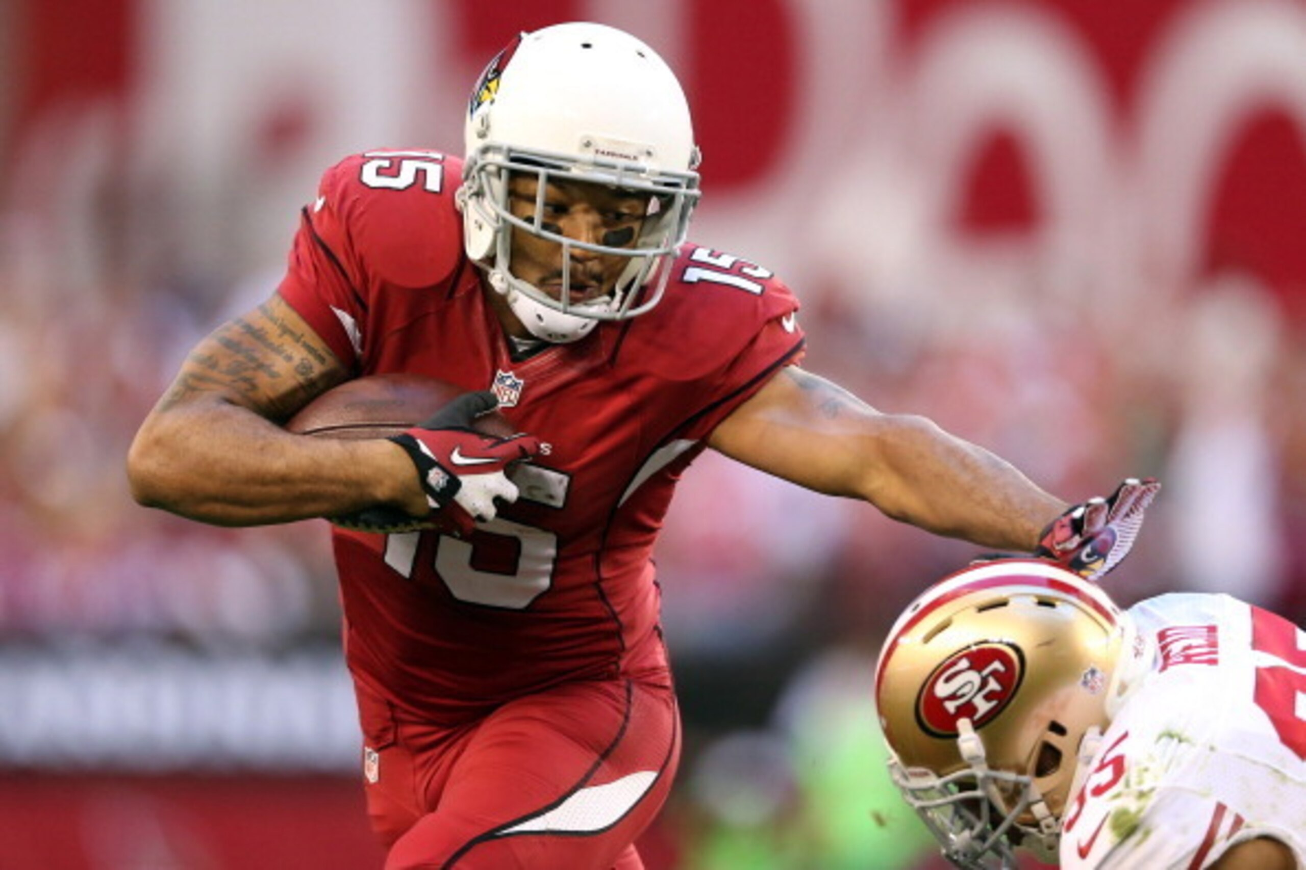 GLENDALE, AZ - DECEMBER 29:   Michael Floyd #15 of the Arizona Cardinals runs the ball against Eric Reid #35 of the San Francisco 49ers during a game at University of Phoenix Stadium on December 29, 2013 in Glendale, Arizona.  (Photo by Christian Petersen