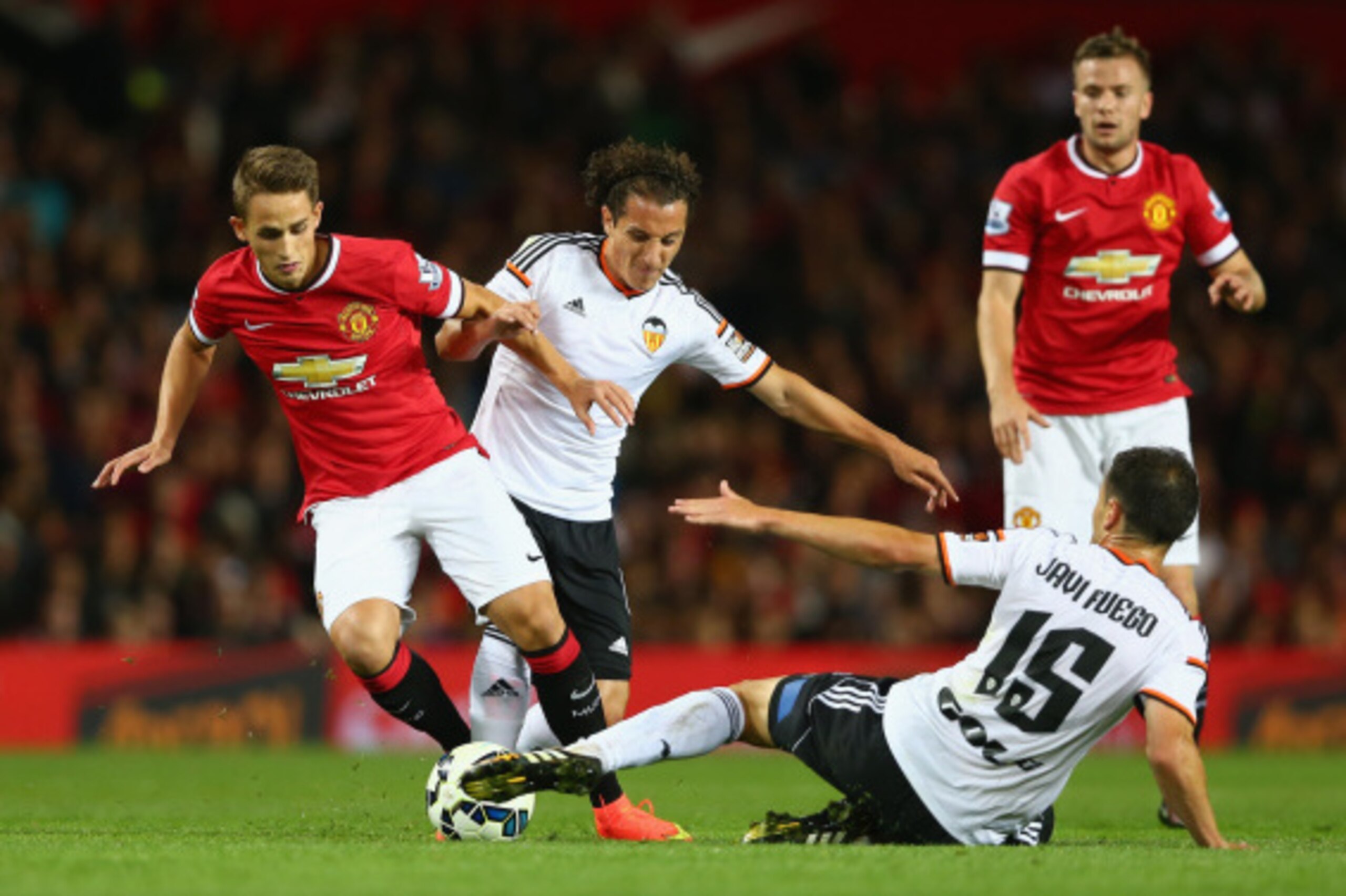 MANCHESTER, ENGLAND - AUGUST 12:  Adnan Januzaj of Manchester United attempts to move past Javi Fuego of Valencia during the Pre Season Friendly match between Manchester United and Valencia at Old Trafford on August 12, 2014 in Manchester, England.  (Phot