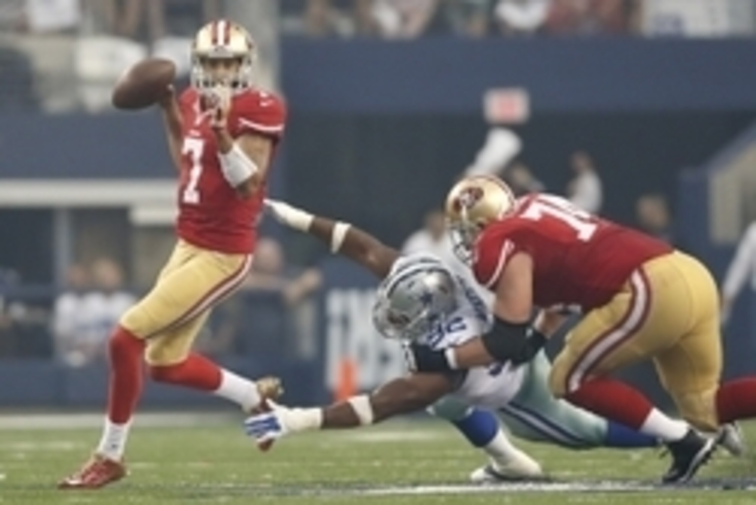 Sep 7, 2014; Arlington, TX, USA; San Francisco 49ers quarterback Colin Kaepernick avoids the sack against Dallas Cowboys defensive end Jeremy Mincey (92) at AT&T Stadium. Mandatory Credit: Matthew Emmons-USA TODAY Sports