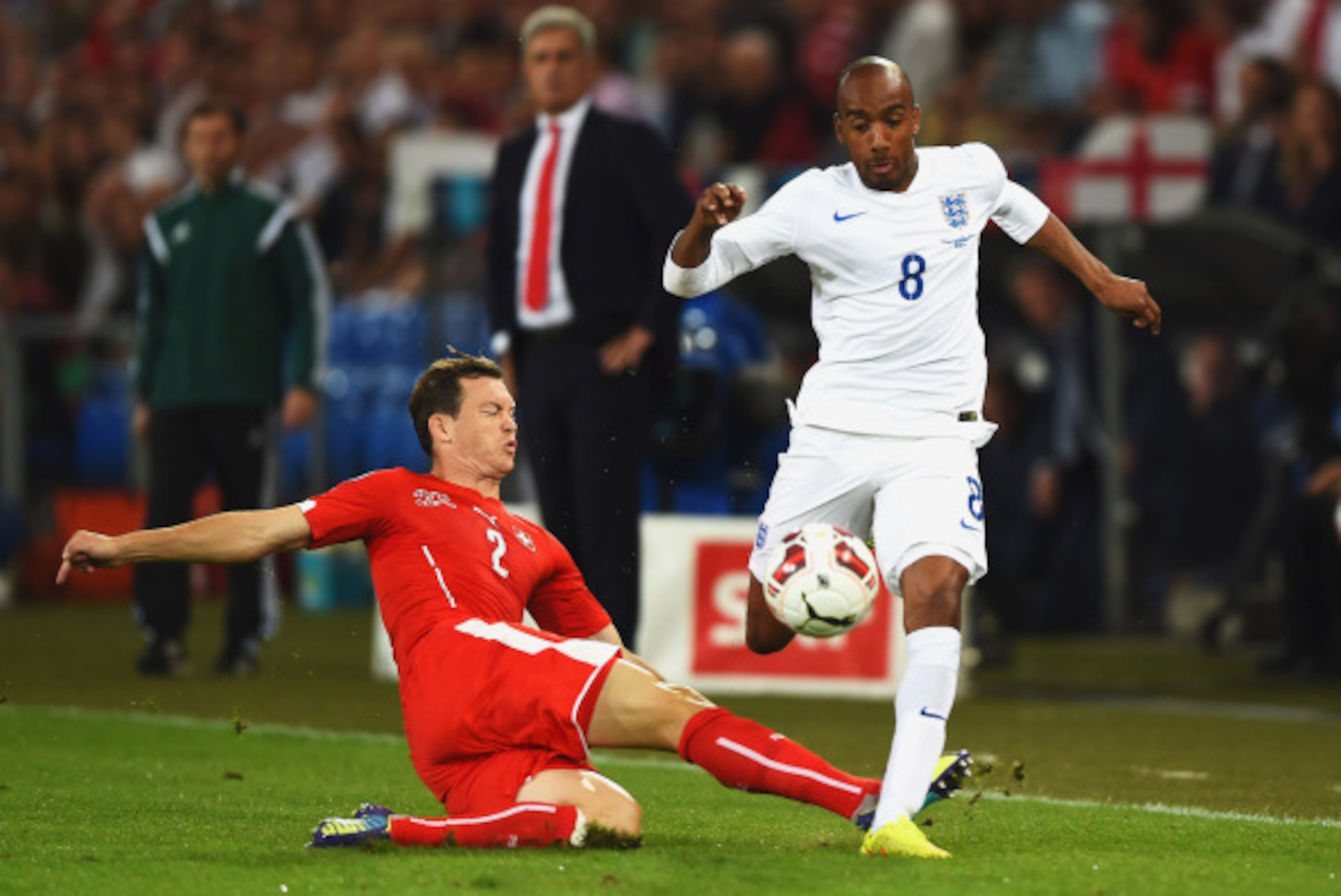 BASEL, SWITZERLAND - SEPTEMBER 08: Fabian Delph of England is tackled by Stephan Lichtsteiner of Switzerland during the UEFA EURO 2016 Group E qualifying match between Switzerland and England at St Jakob-Park on September 8, 2014 in Basel, Switzerland. BASEL, SWITZERLAND - SEPTEMBER 08: Fabian Delph of England is tackled by Stephan Lichtsteiner of Switzerland during the UEFA EURO 2016 Group E qualifying match between Switzerland and England at St Jakob-Park on September 8, 2014 in Basel, Switzerland.