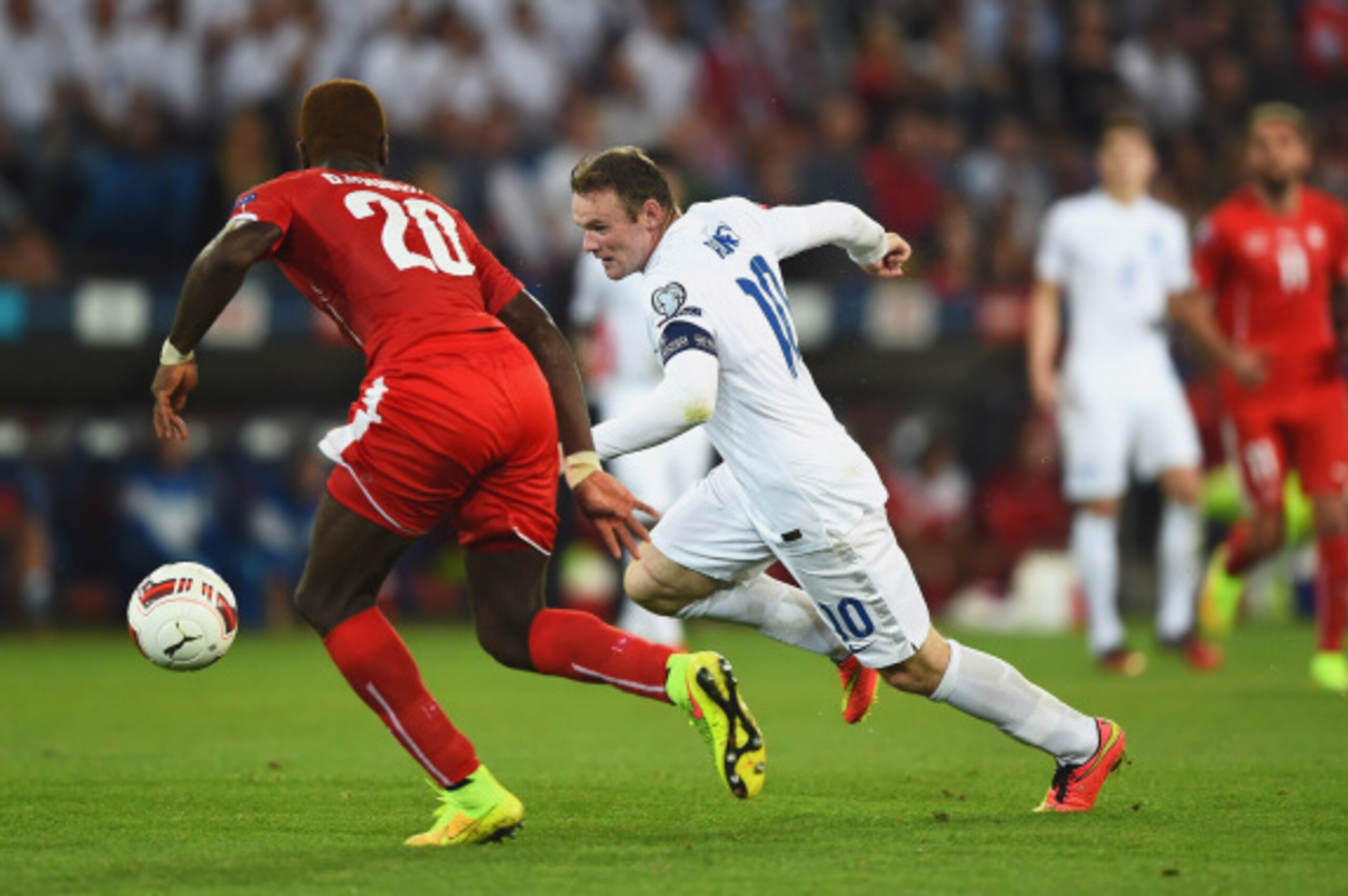 BASEL, SWITZERLAND - SEPTEMBER 08:  Wayne Rooney of England takes on Johan Djourou of Switzerland during the UEFA EURO 2016 Group E qualifying match between Switzerland and England at St Jakob-Park on September 8, 2014 in Basel, Switzerland.  (Photo by La