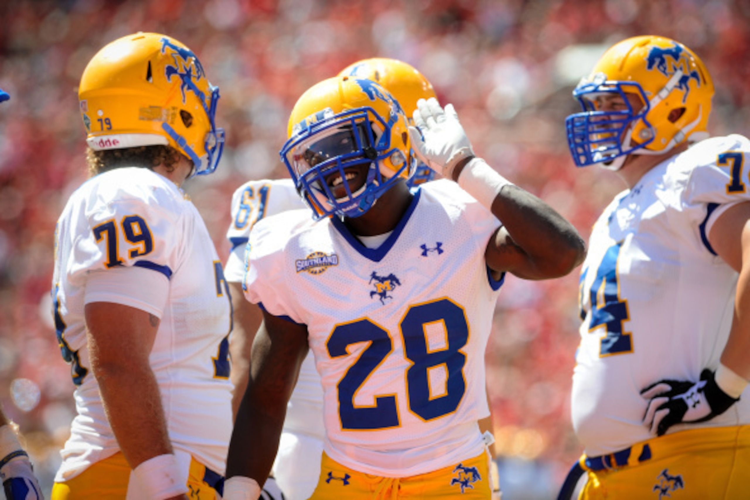 LINCOLN, NE - SEPTEMPER 6: Running back Derrick Milton #28 of the McNeese State Cowboys encourages the Nebraska Cornhuskers crowd during their game at Memorial Stadium on September 6, 2014 in Lincoln, Nebraska. Nebraska defeated McNeese State 31-24. (Phot