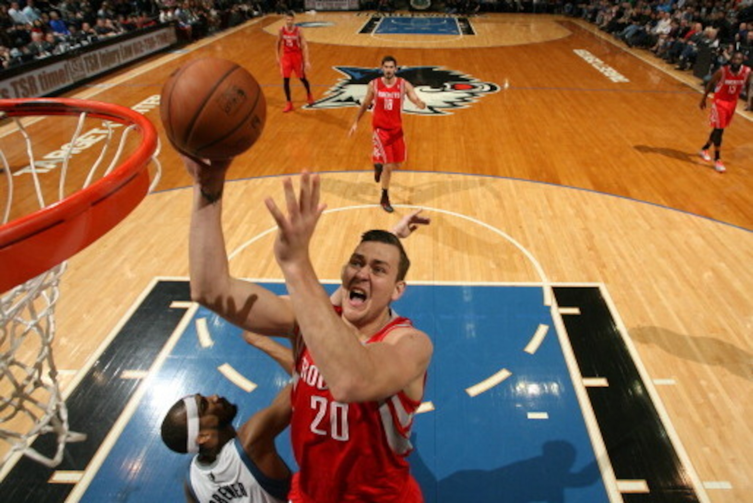 MINNEAPOLIS, MN - April 11: Donatas Motiejunas #20 of the Houston Rockets drives to the basket during the game against the Minnesota Timberwolves on April 11, 2014 at Target Center in Minneapolis, Minnesota. NOTE TO USER: User expressly acknowledges and a