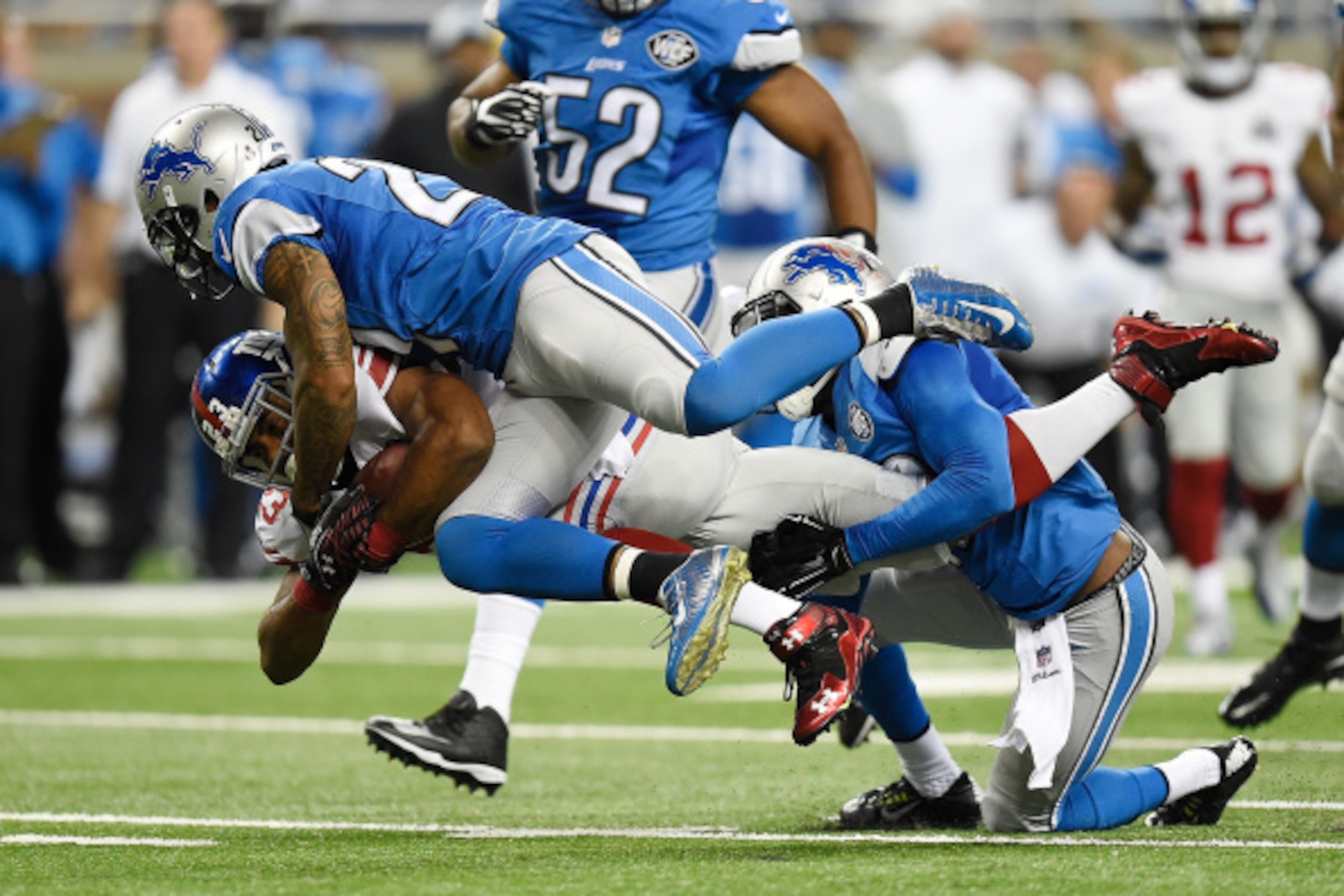 DETROIT, MI - SEPTEMBER 08:  Rashad Jennings #23 of the New York Giants is tackled by Glover Quin #27 and Isa Abdul-Quddus #42 of the Detroit Lions during the second quarter at Ford Field on September 8, 2014 in Detroit, Michigan. (Photo by Joe Sargent/Ge