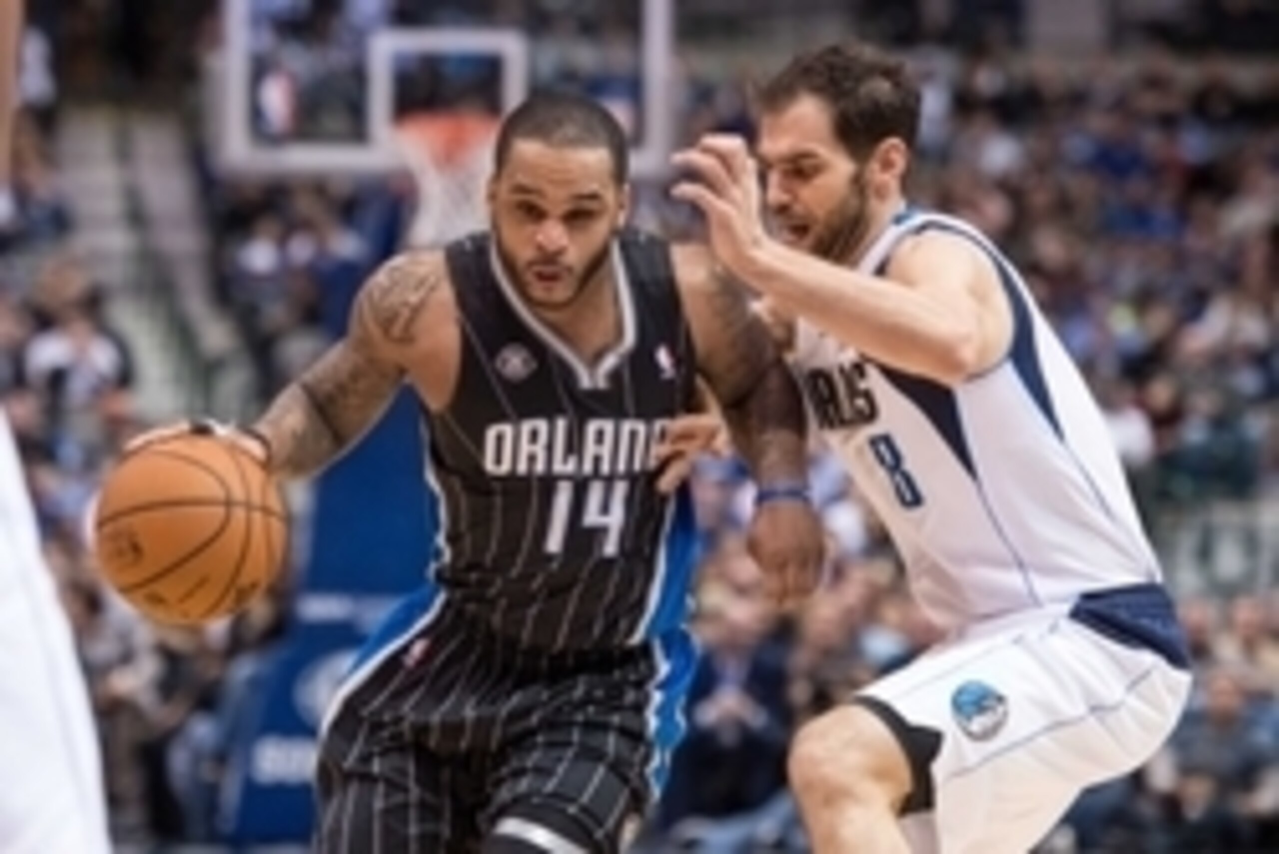 Jan 13, 2014; Dallas, TX, USA; Orlando Magic point guard Jameer Nelson (14) drives to the basket past Dallas Mavericks point guard Jose Calderon (8) during the game at the American Airlines Center. The Mavericks defeated the Magic 107-88. Mandatory Credit