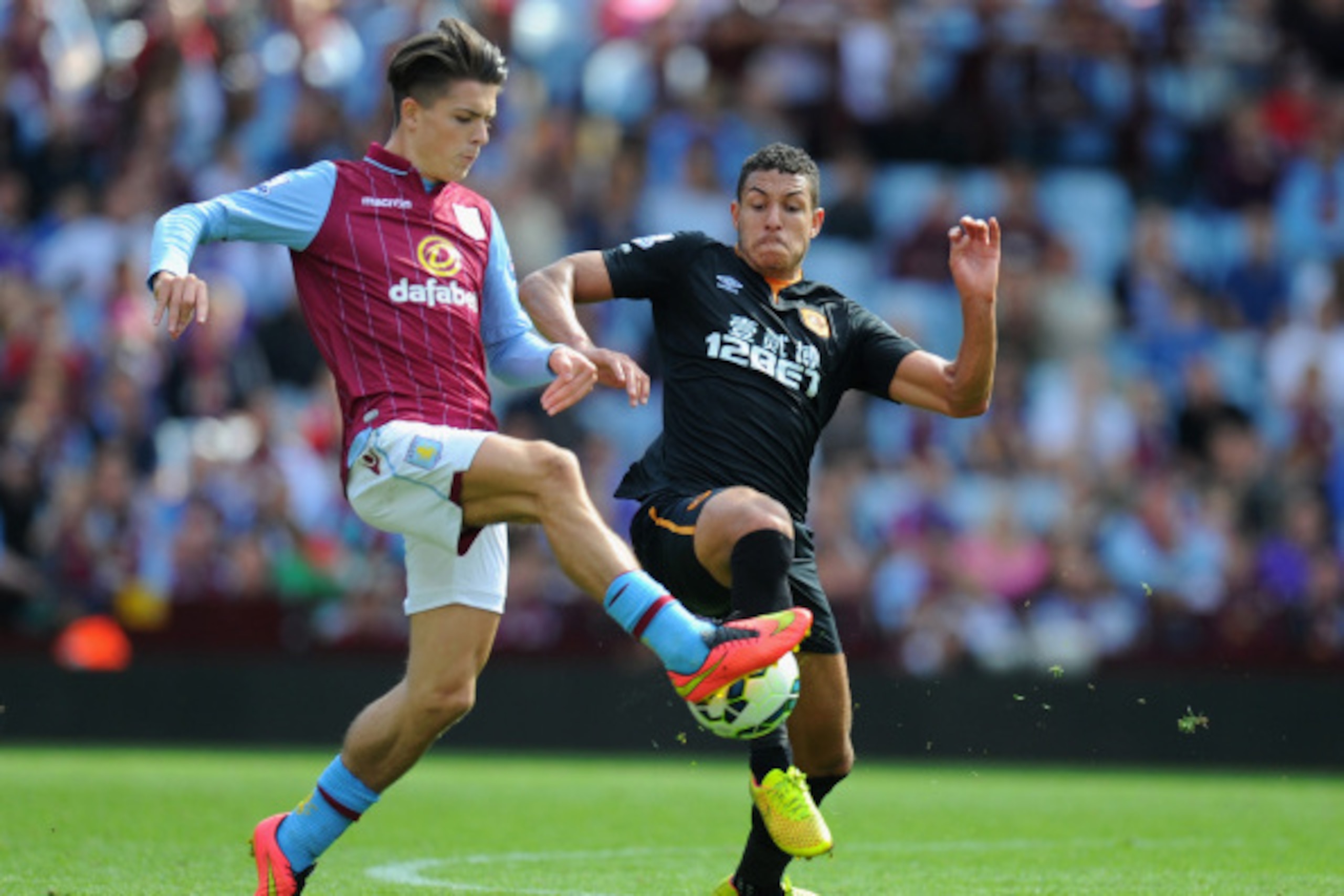 BIRMINGHAM, ENGLAND - AUGUST 31:  Hull City player Jake Livermore (r) challenges Jack Grealish of Villa during the Barclays Premier League match between Aston Villa and Hull City at Villa Park on August 31, 2014 in Birmingham, England.  (Photo by Stu Fors