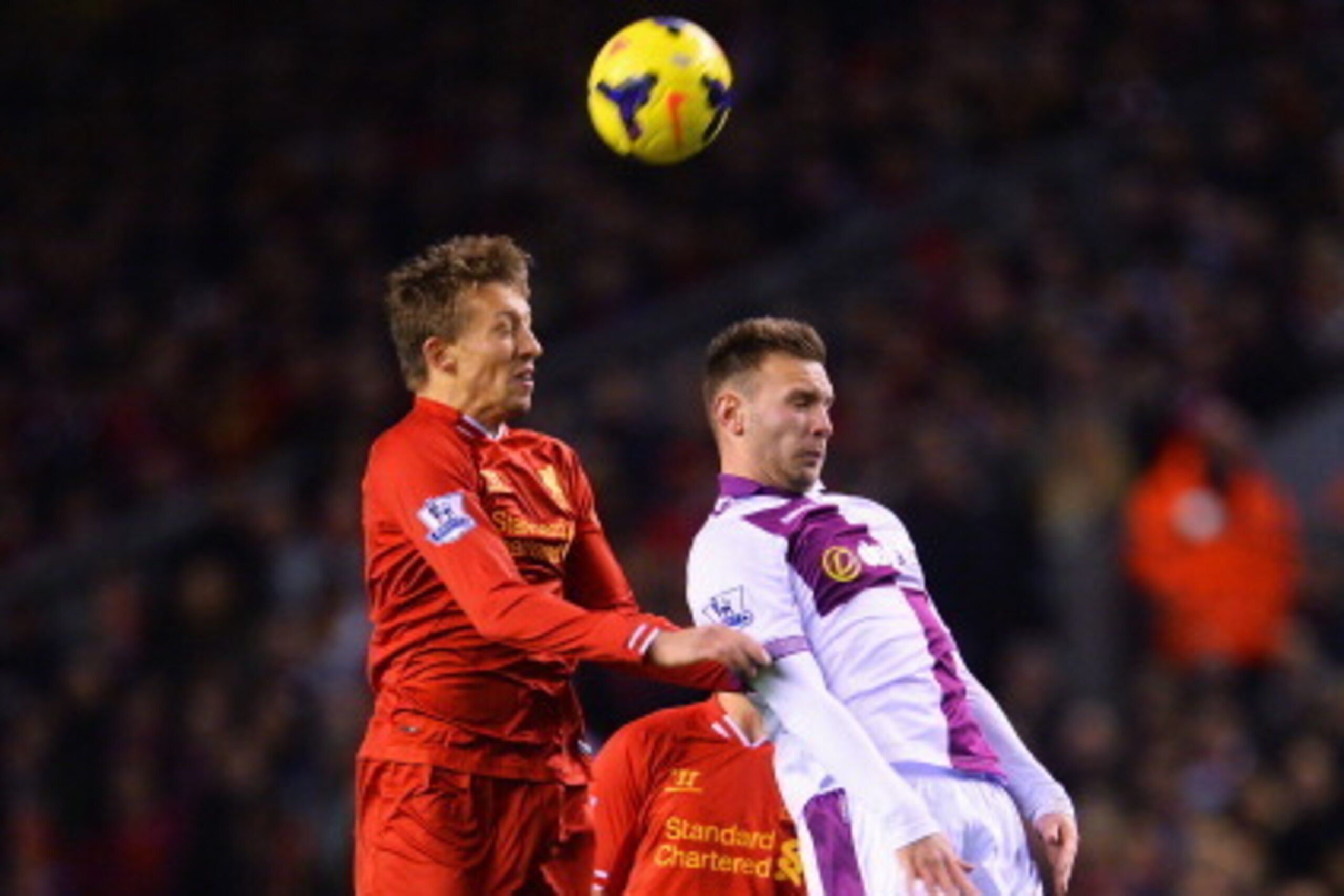 LIVERPOOL, ENGLAND - JANUARY 18: Lucas of Liverpool wins a header with Andreas Weimann of Aston Villa during the Barclays Premier League match between Liverpool and Aston Villa at Anfield on January 18, 2014 in Liverpool, England.  (Photo by Michael Regan