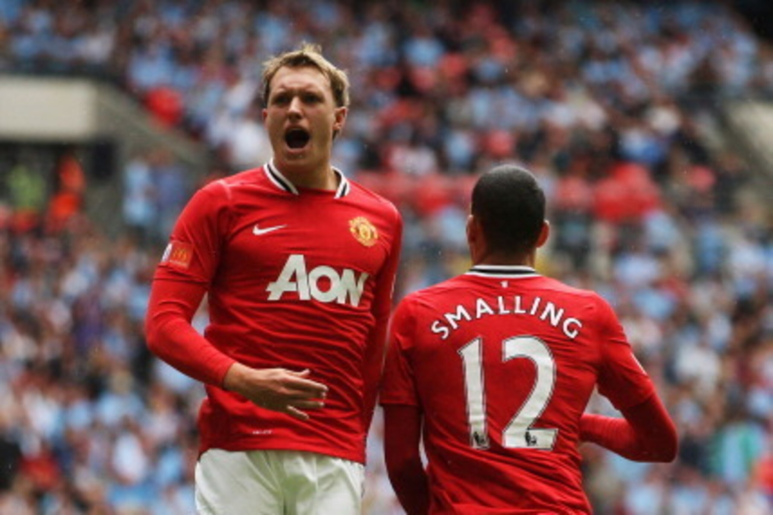 LONDON, ENGLAND - AUGUST 07:  Phil Jones of Manchester United celebrates with goalscorer Chris Smalling during the FA Community Shield match sponsored by McDonald's between Manchester City and Manchester United at Wembley Stadium on August 7, 2011 in Lond