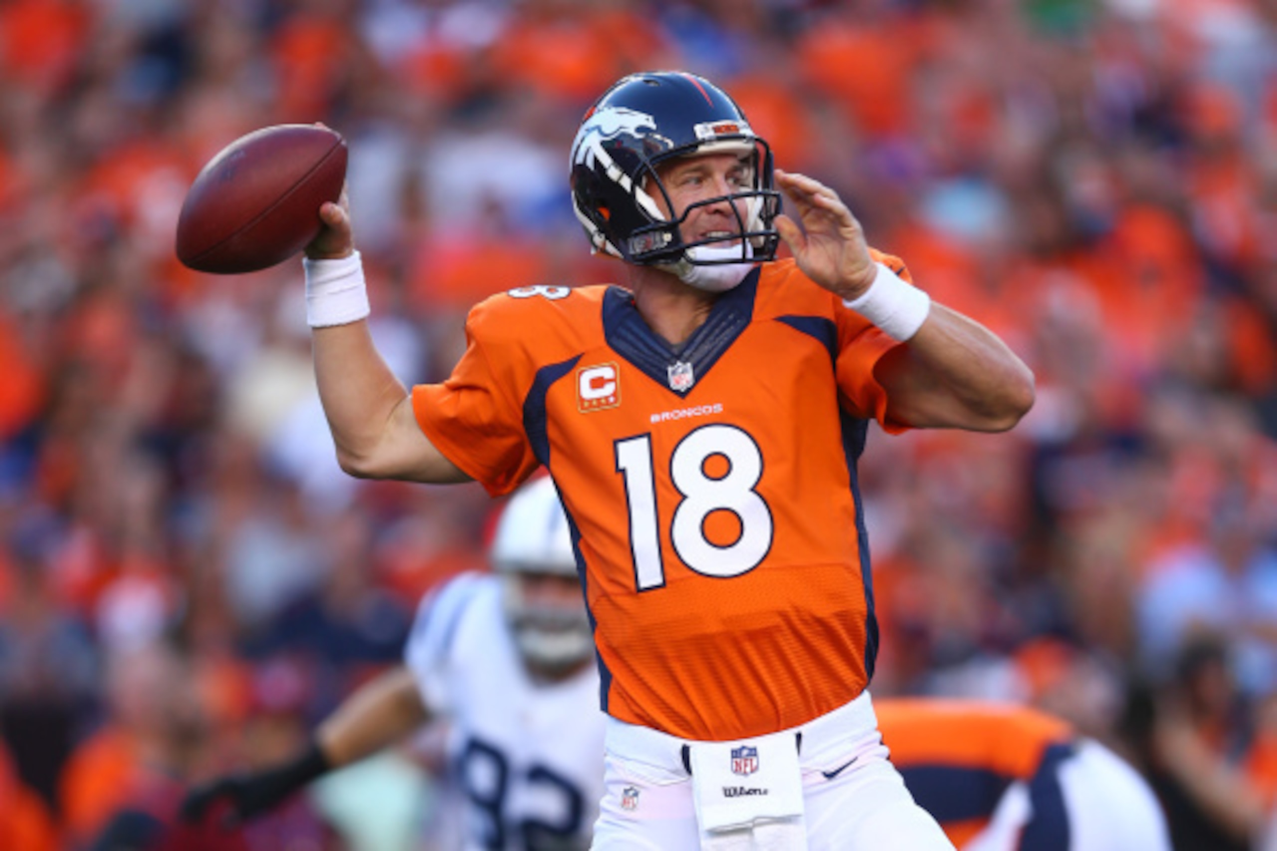 DENVER, CO - SEPTEMBER 7:  Quarterback Peyton Manning #18 of the Denver Broncos passes against the Indianapolis Colts in the first quarter of a game at Sports Authority Field at Mile High on September 7, 2014 in Denver, Colorado.  (Photo by Jeff Gross/Get